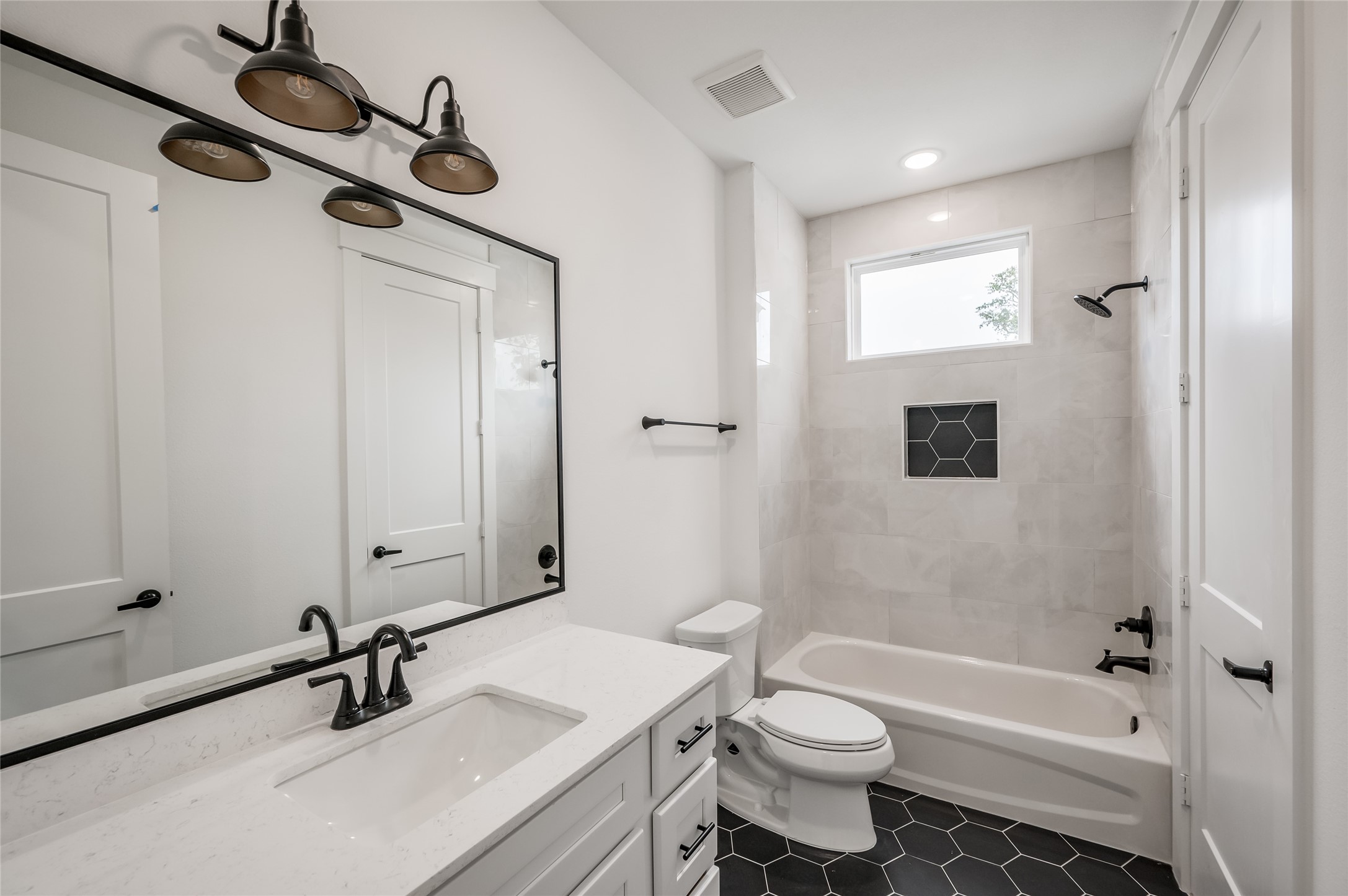 The secondary bath, with its tub and shower combo, is ready for busy mornings