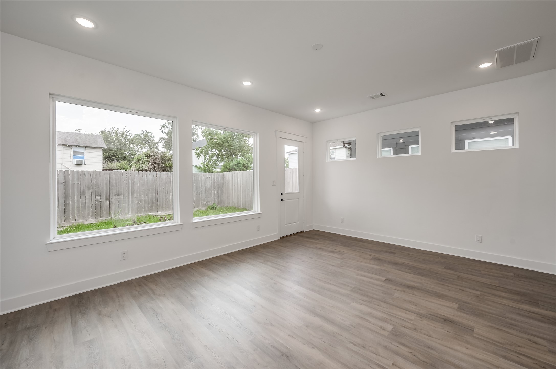 A wall of windows along the back of the living room fills the space with natural light throughout the day