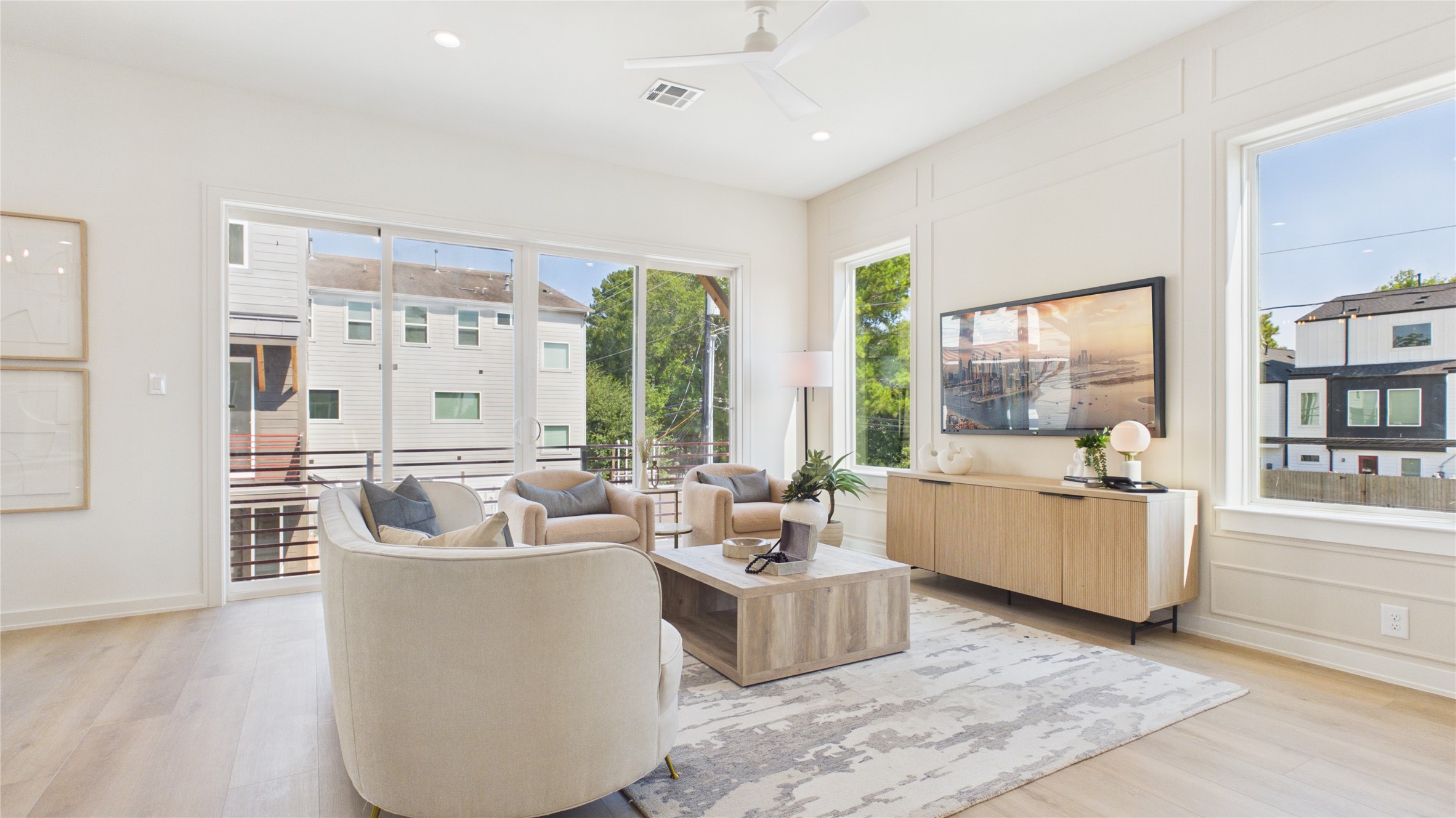 Living room featuring double pane windows and an oversized balcony.