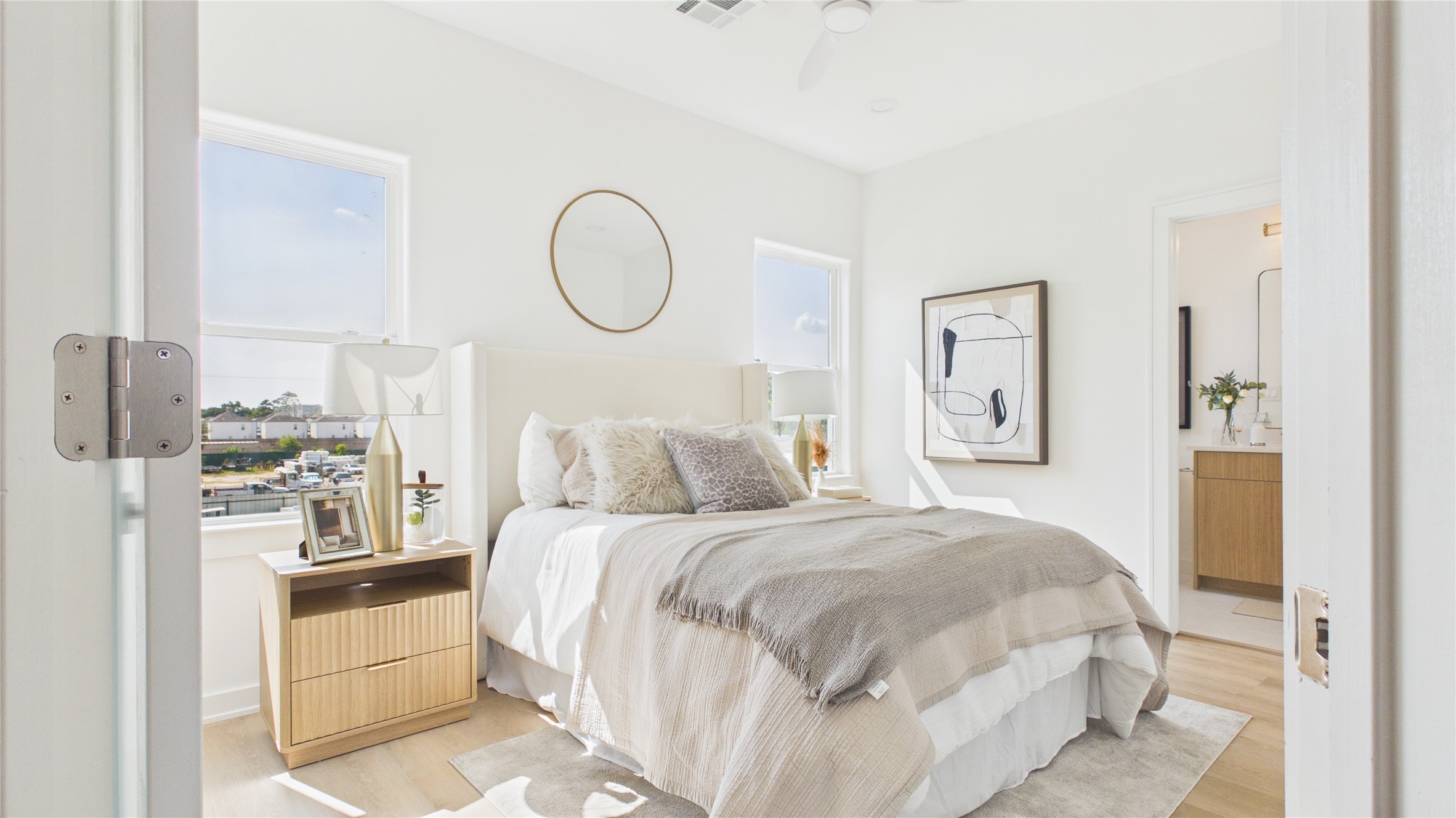 Inviting secondary bedroom with abundant natural light, and a modern ensuite bathroom.