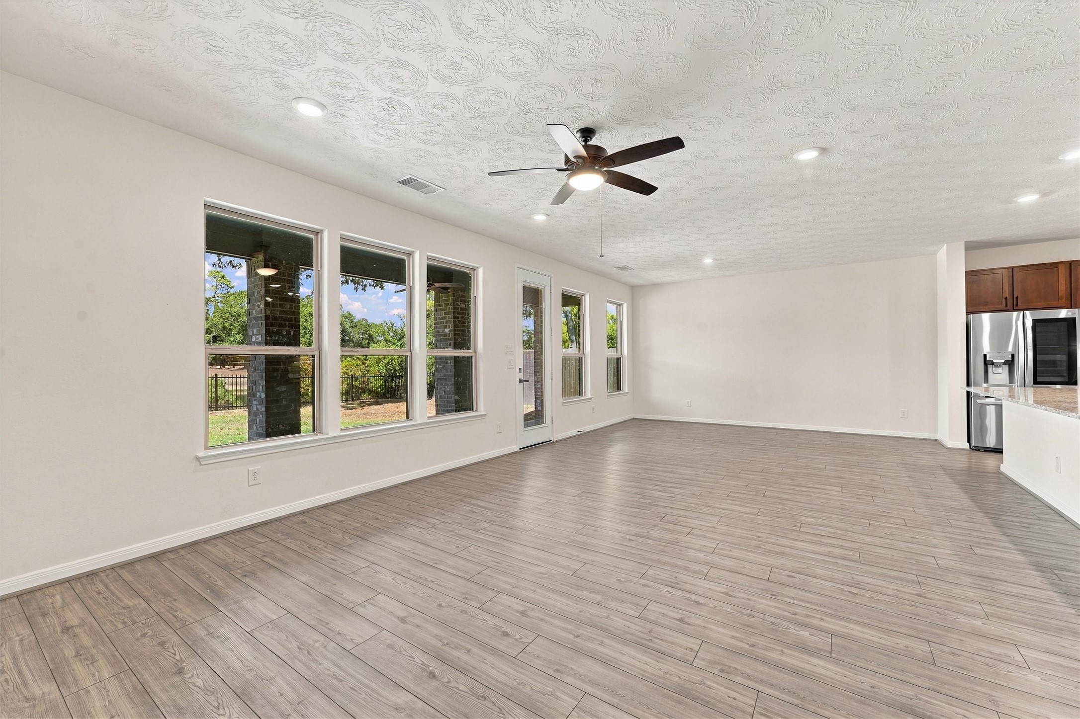 Open concept living with a wall of wondows overlooking the gorgeous scenery in back!