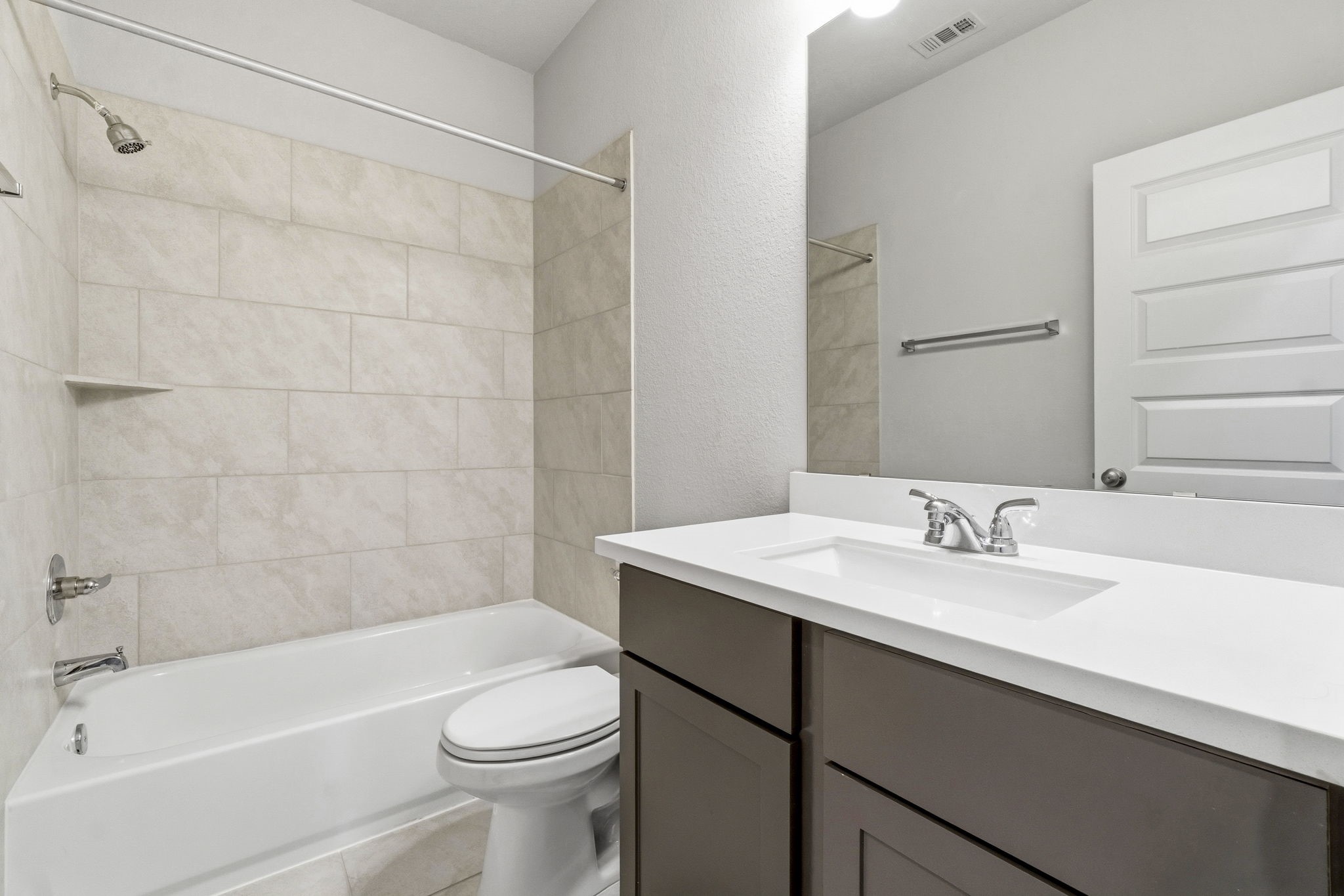 The guest ensuite bath features a convenient tub and shower combination.