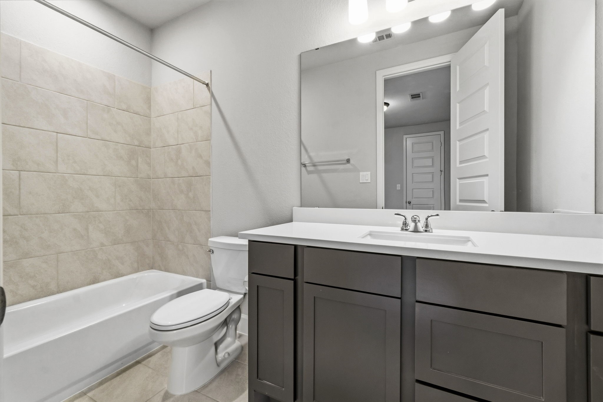 A third full bathroom upstairs provides added convenience for the secondary bedrooms, game room, and media room.