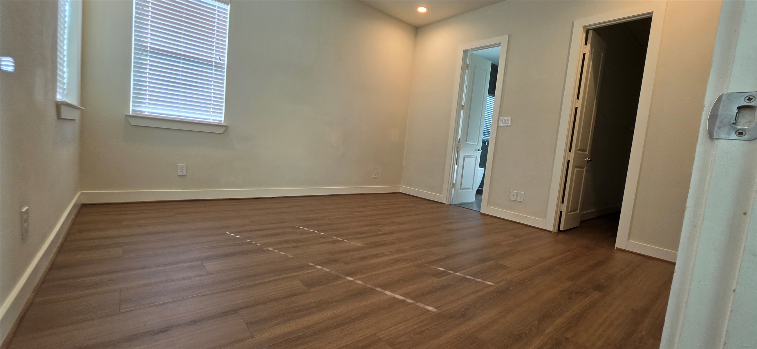 Primary bedroom with laminate floors