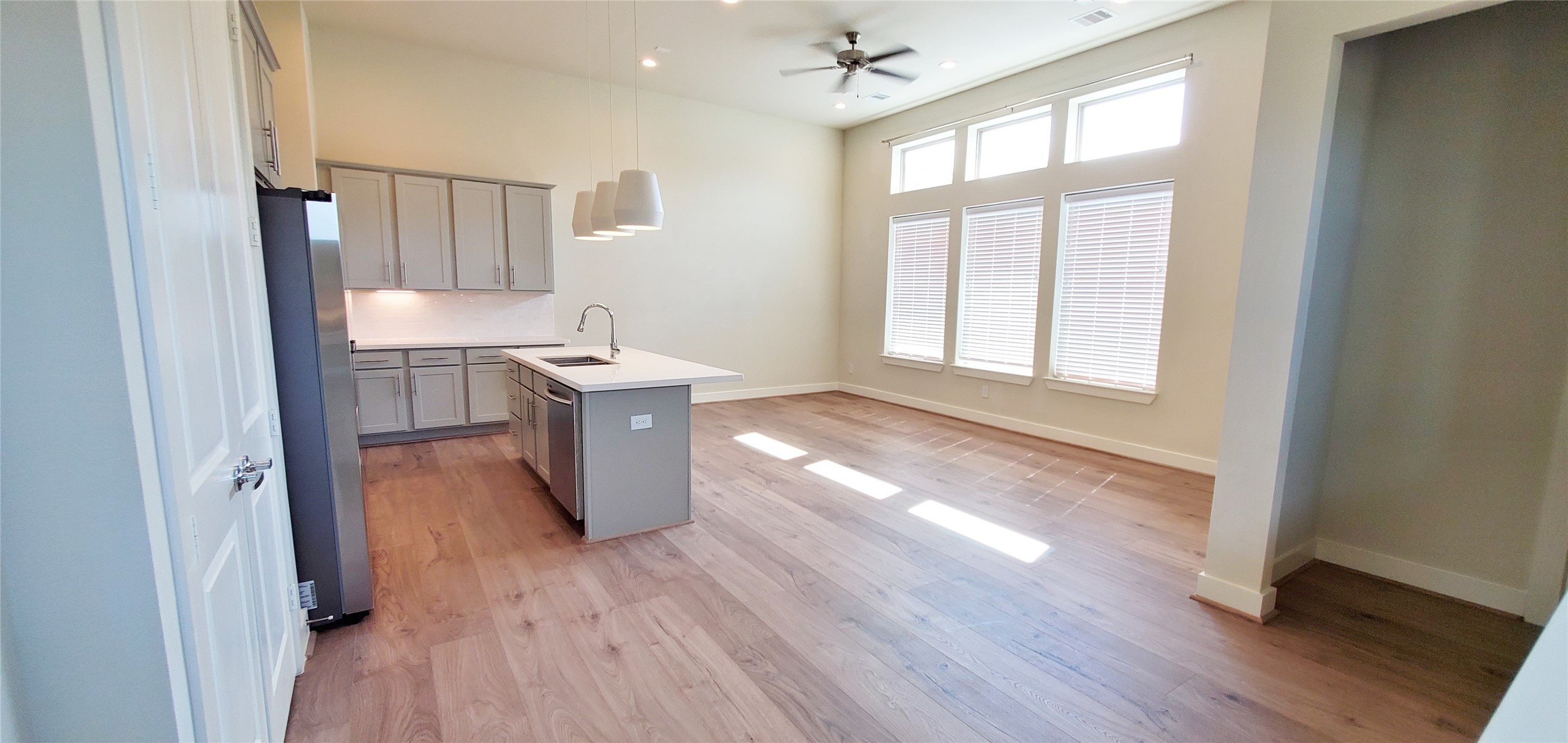 Kitchen open to living room.  Higch ceilings and lots of natural light