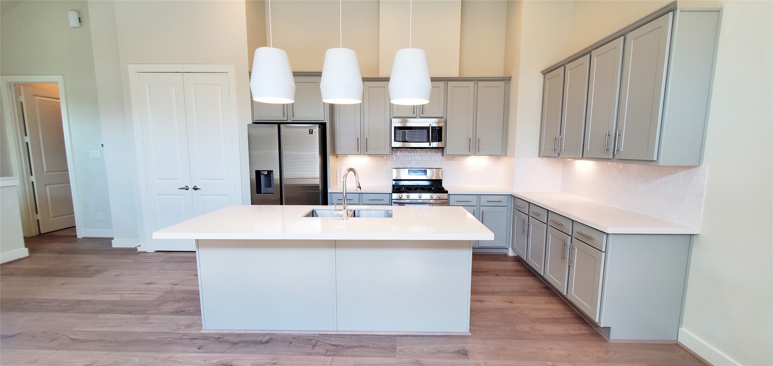Large kitchen with island overlooking family room and dining area.
