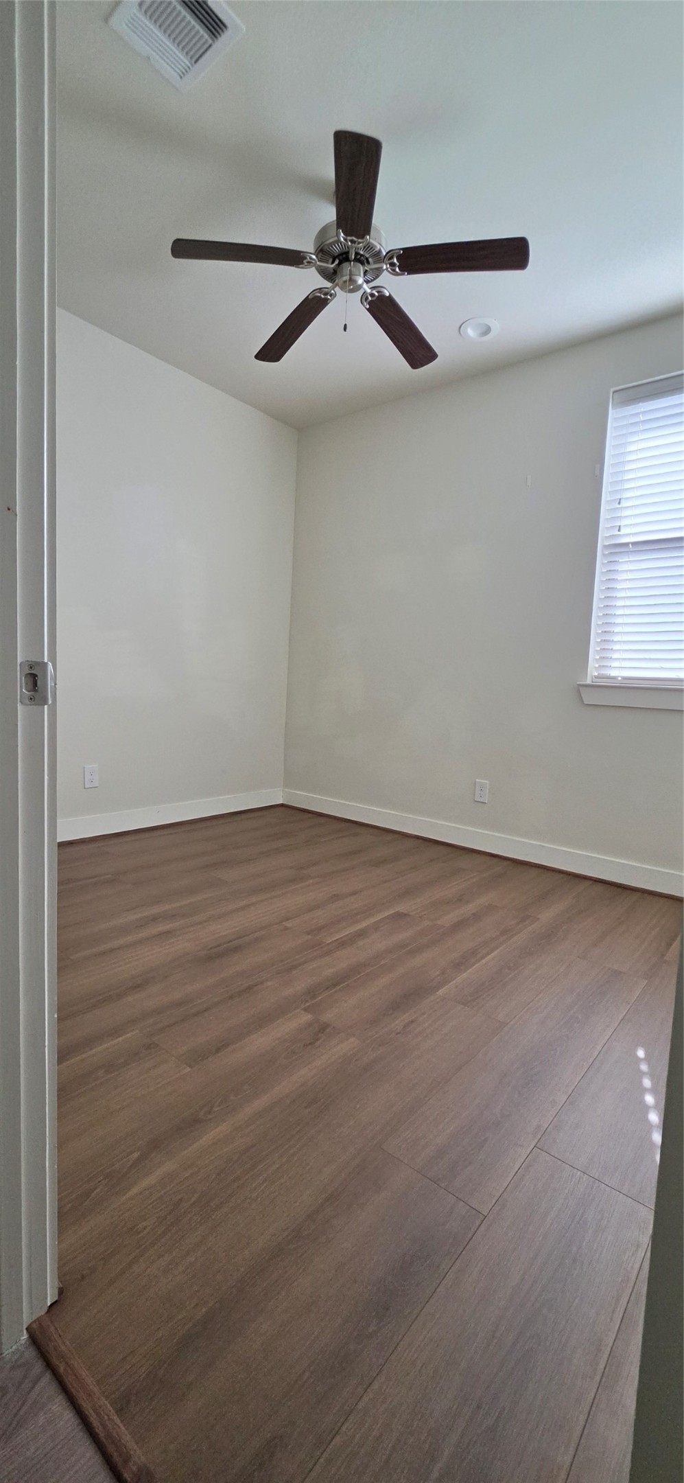 Another view of secondary bedroom with laminate floors