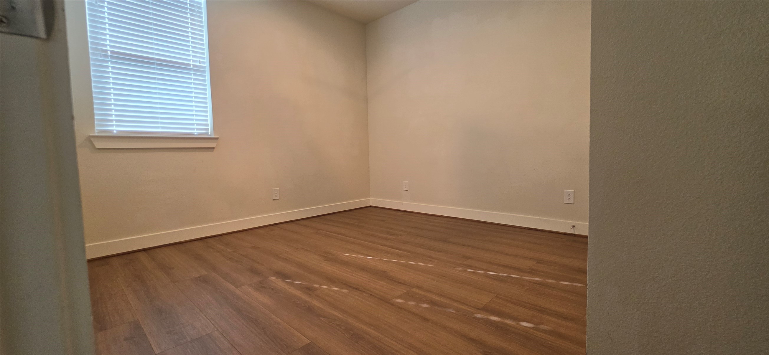 Secondary bedroom with laminate floors