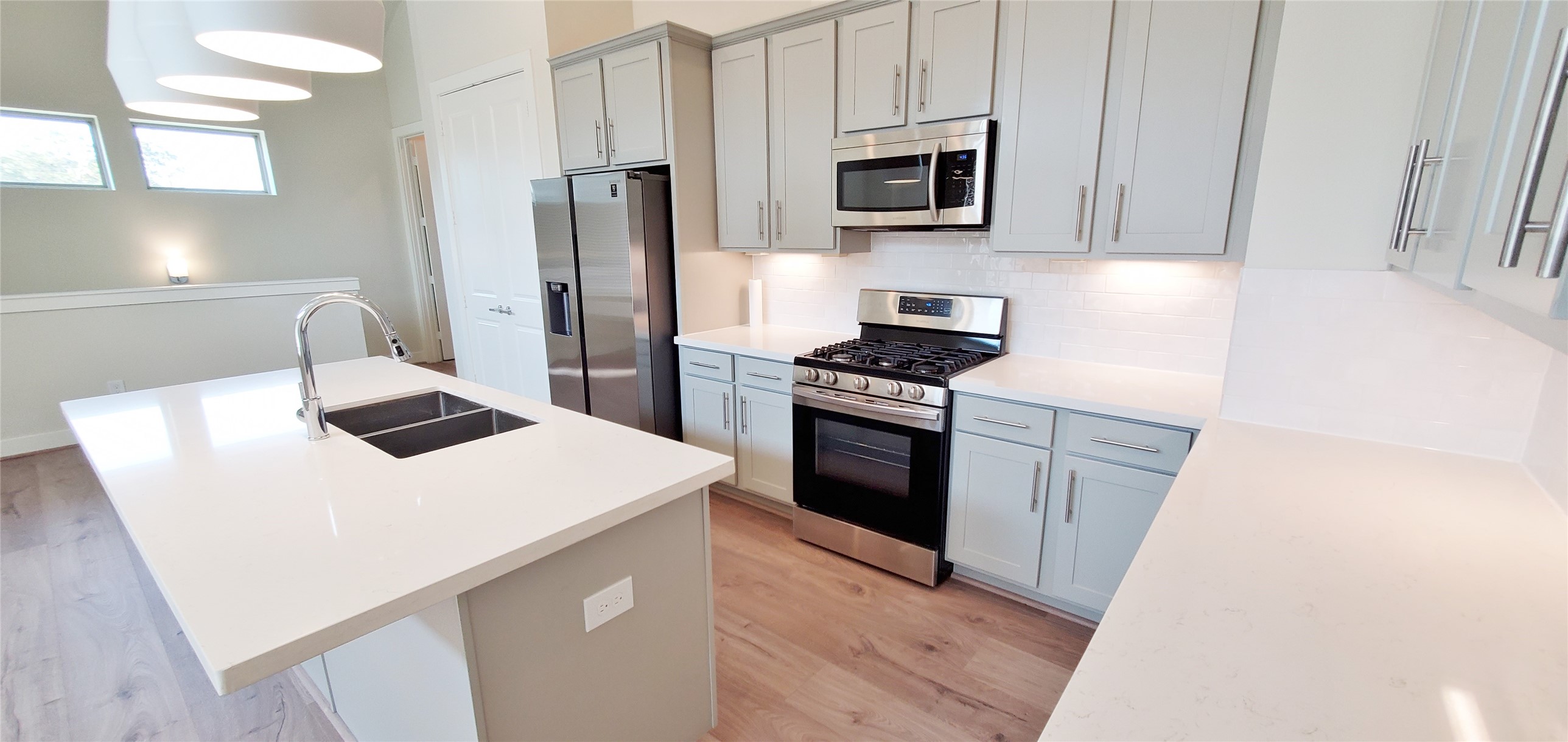 Large kitchen with island overlooking family room and dining area.