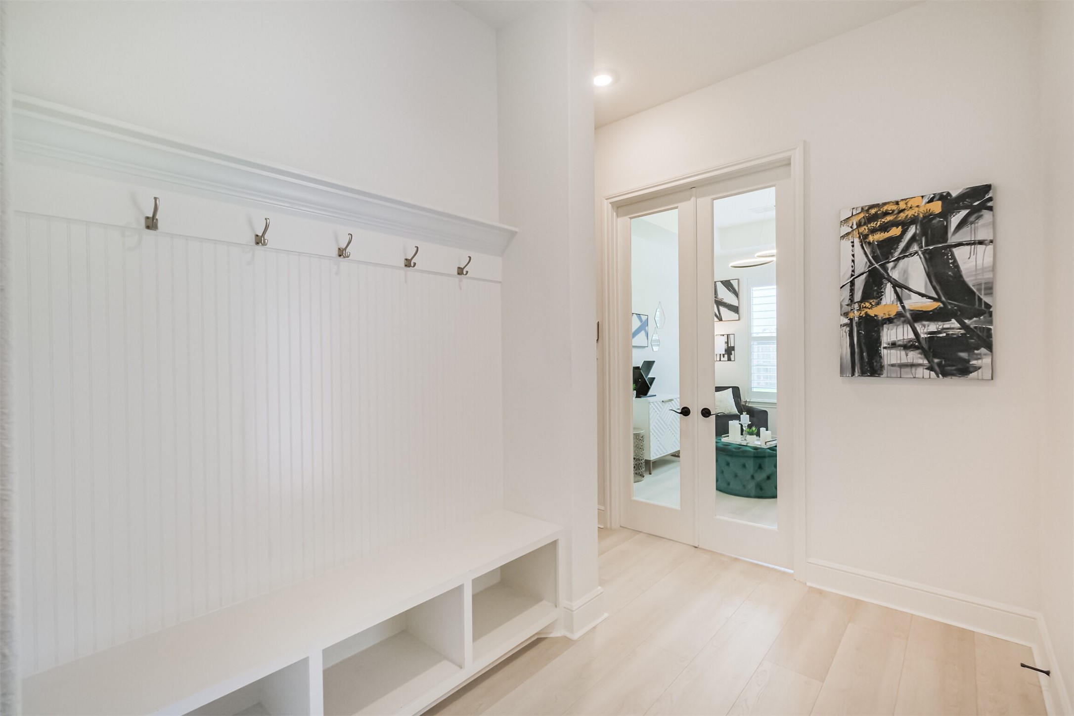 Back inside the main residence, the thoughtfully designed mudroom is conveniently positioned just off the garage and adjacent to the private guest suite, providing a functional transition space for everyday living.
