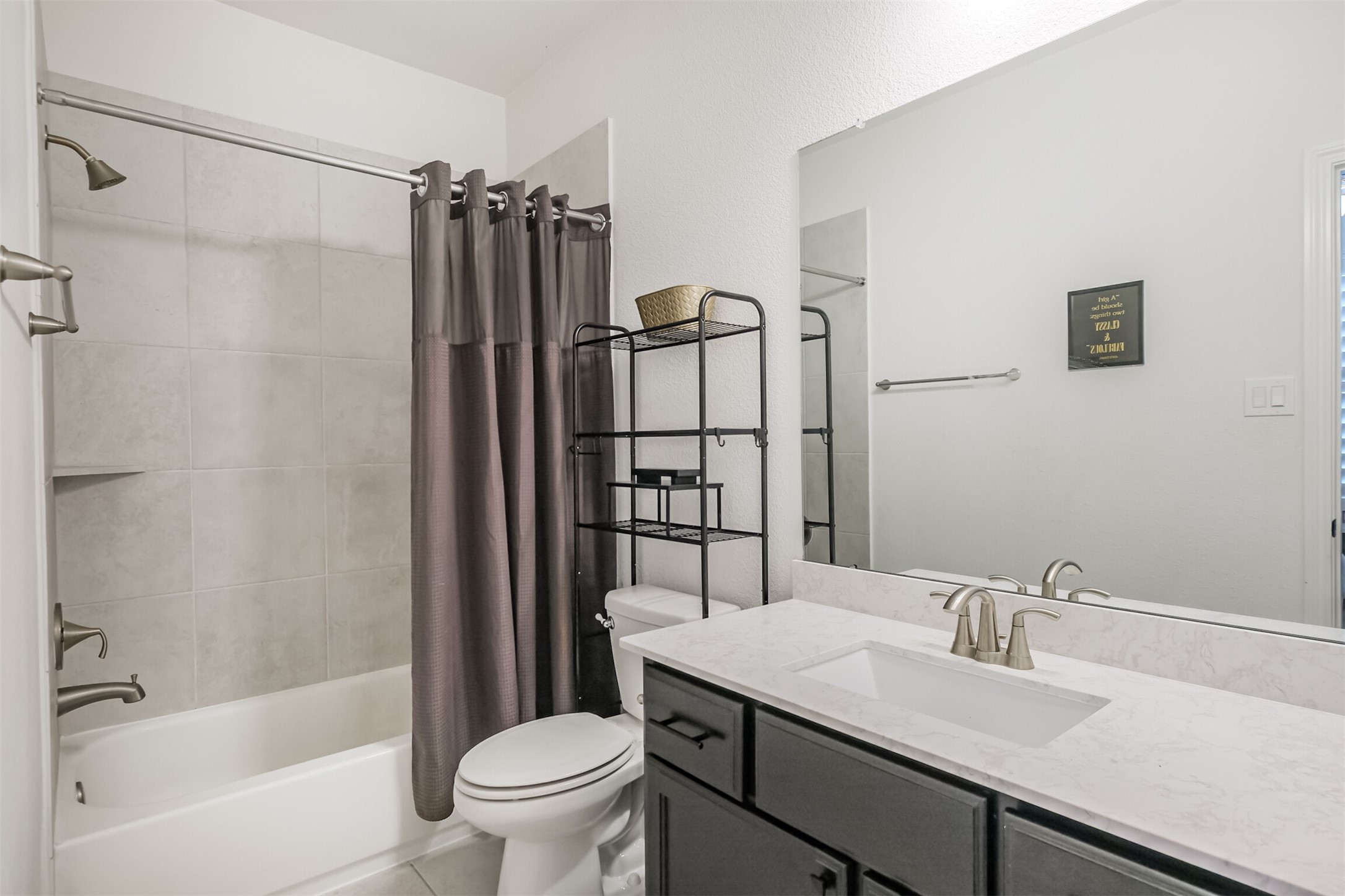 Stylish sixth bathroom showcasing modern finishes, sleek quartz countertops, and chic contemporary details, creating a polished and sophisticated space.