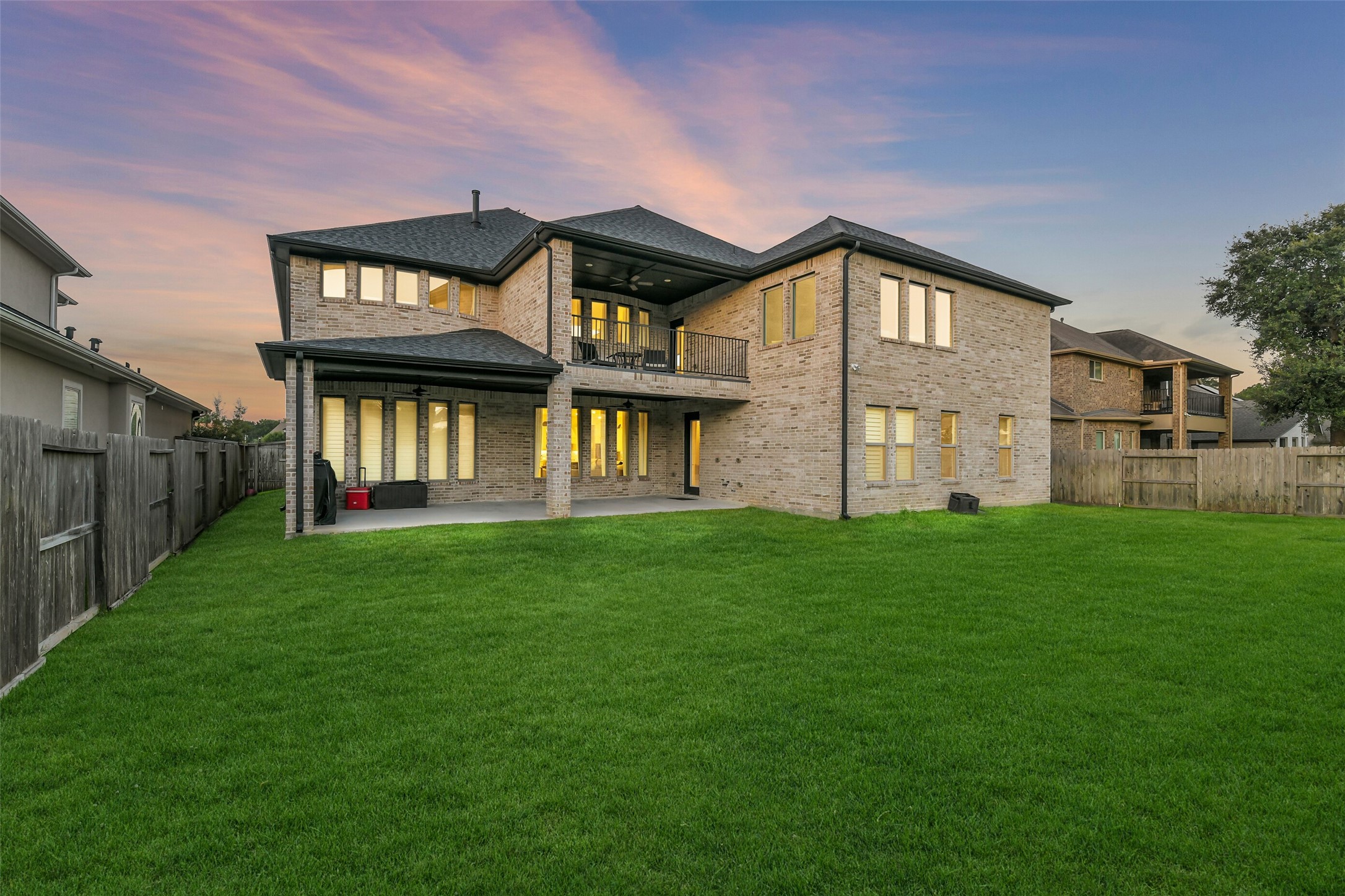 Exquisite backyard retreat showcasing an expansive Texas-sized covered patio and elegant second-story balcony, all overlooking beautifully manicured, private grounds. The generous backyard offers an exceptional canvas for a resort-inspired pool and outdoor oasis, while prewiring for gas and water provides the foundation for a custom outdoor kitchencreating a sophisticated setting for grand-scale entertaining and effortless outdoor living.
