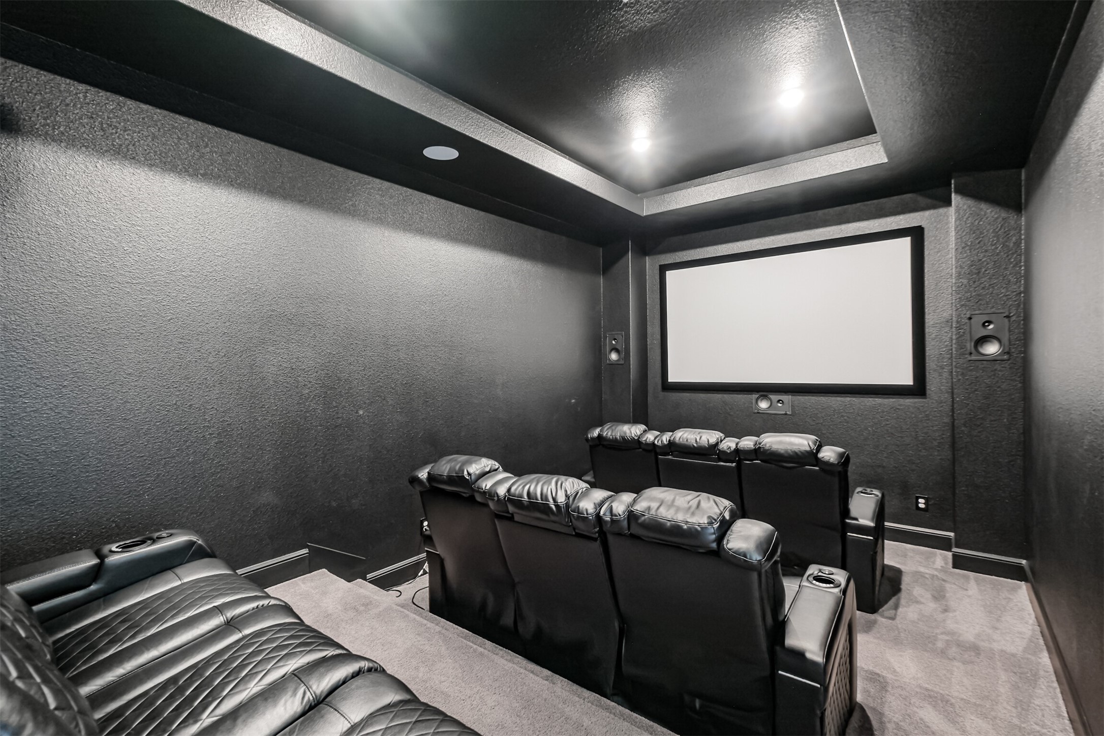 Impressive dedicated media room featuring a built-in Epson Pro Cinema 4050 projector and 100 inch screen, with generous space to create the ultimate at-home theater experience. Perfect for movie nights, sporting events, and entertaining, this expansive room brings cinematic entertainment right at home.