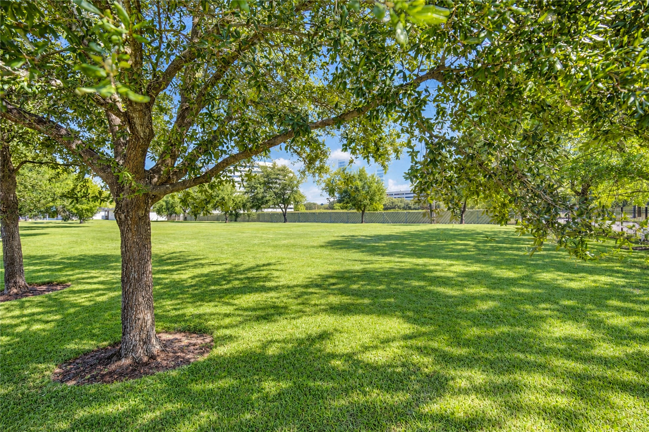 Beautiful neighborhood green space with mature shade trees, just a short walk from the home. Residents also enjoy access to a nearby community swimming pool!