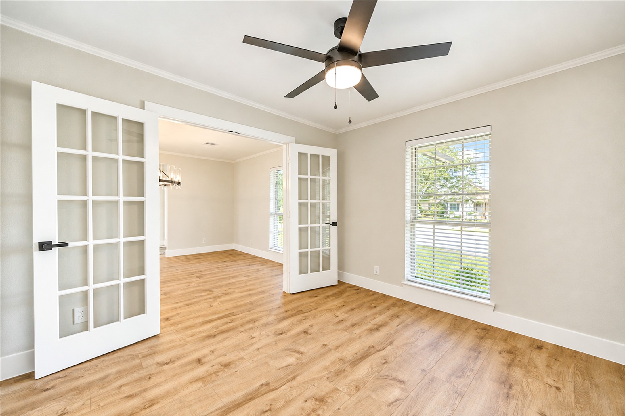Beautifully converted from a formal dining room into a private, versatile flex space featuring elegant French doors, a secondary entrance to the kitchen, new wide-plank engineered wood flooring, and a new ceiling fan. Ideal for a home office, game room, fitness room, nursery, or media room!