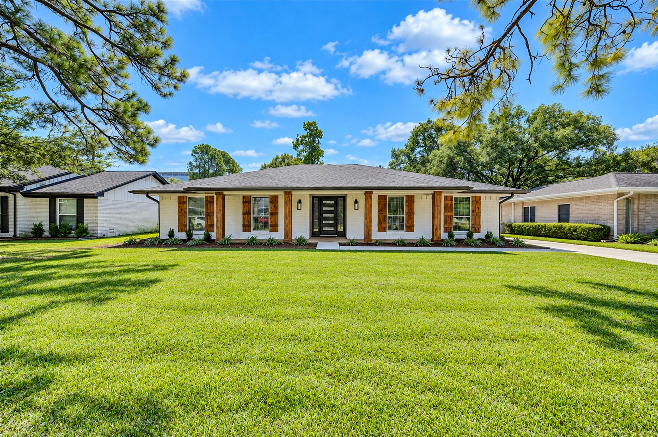 Beautifully renovated home featuring a new roof, striking black-and-white exterior, and custom cedar shutters and accents. Beautifully renovated home featuring a new roof, striking black-and-white exterior, and custom cedar shutters and accents.