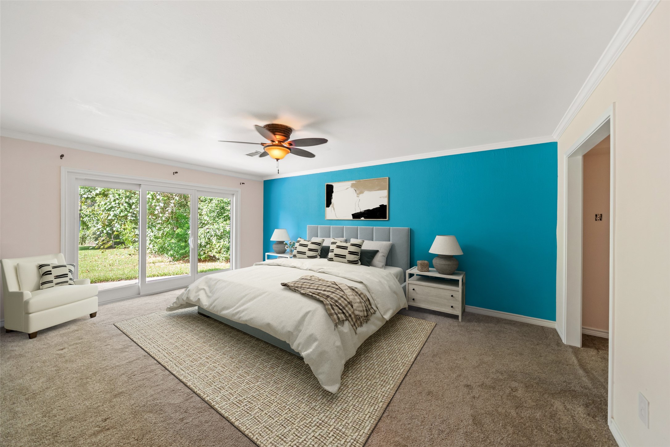 One of the LARGE primary bedrooms in this beautiful property.  Wake up to a gorgeous view of the water!!  Doors lead out to the backyard patio.  Perfect for a small seating area outside your back window.