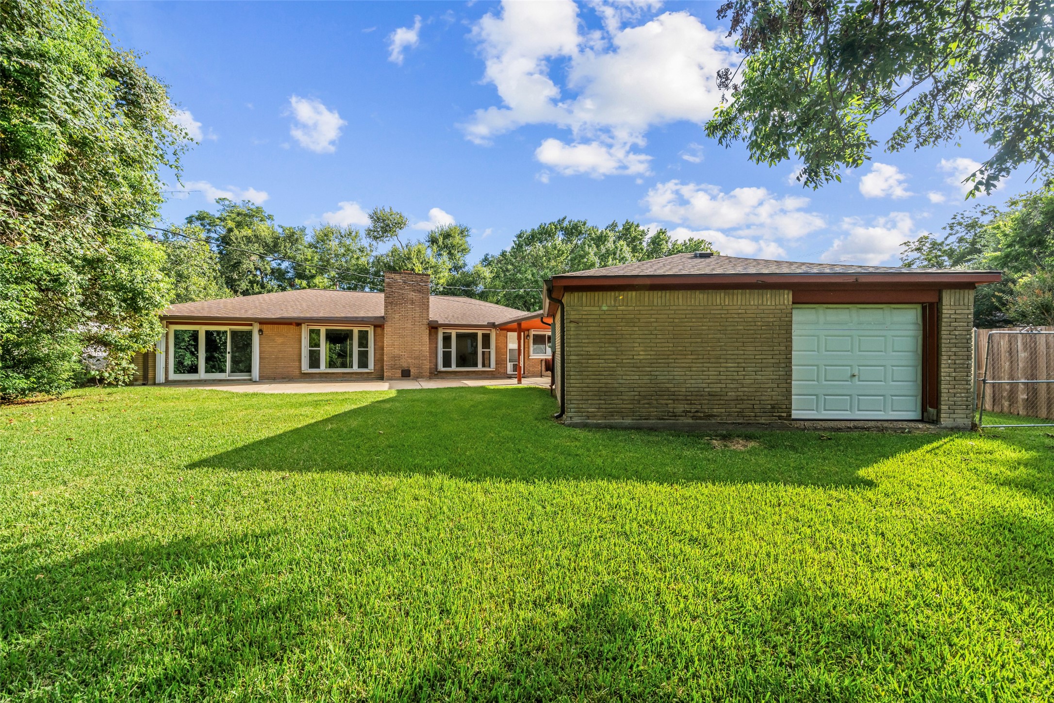 The detached 2 car garage on the right has a door that leads directly out towards the bayou.  Inside the garage is a storage area that allows you to slide your kayak out the garage door and down to your private boat pier!  Additional attic space in garage for plenty of storage and a workspace with a workbench and storage.
