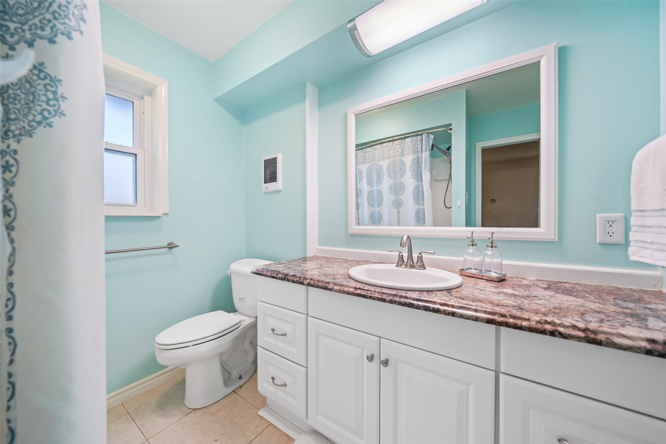 Primary bathroom number one has lots of counterspace and cabinet space!