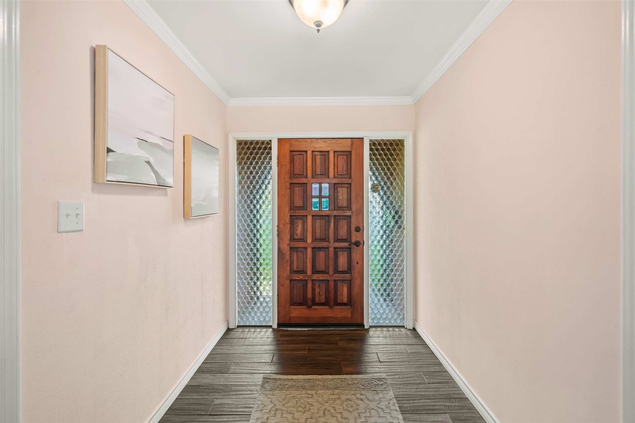 Front entry way with corrugated sidelights that bring in the natural light without losing your privacy. Interior walls are insulated so the interior of the home is very quiet!!