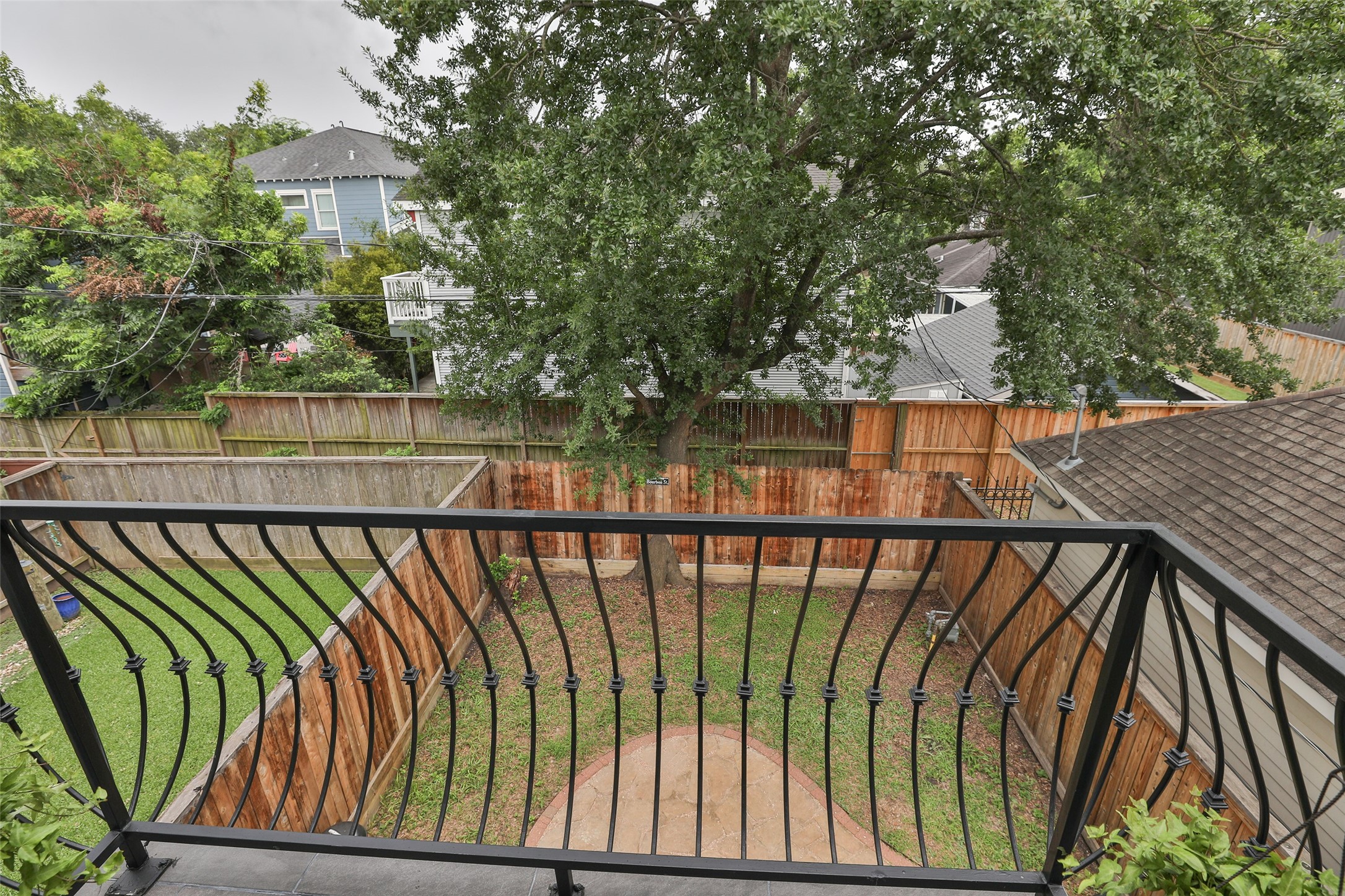 Balcony in primary bedroom with a view of the backyard.