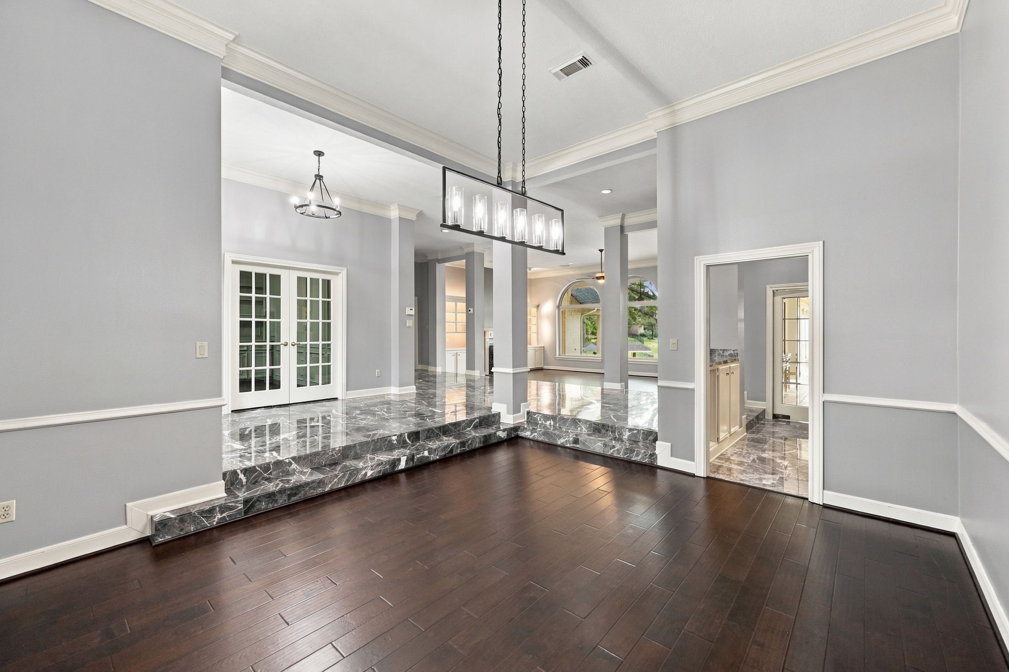 From the opposite side of the Formal Dining Room, you'll notice the beautiful architectural columns and soothing neutral paint palette that carry throughout the home. The cohesive colors and thoughtful design create a seamless flow between the living spaces, enhancing the home's open and welcoming feel.