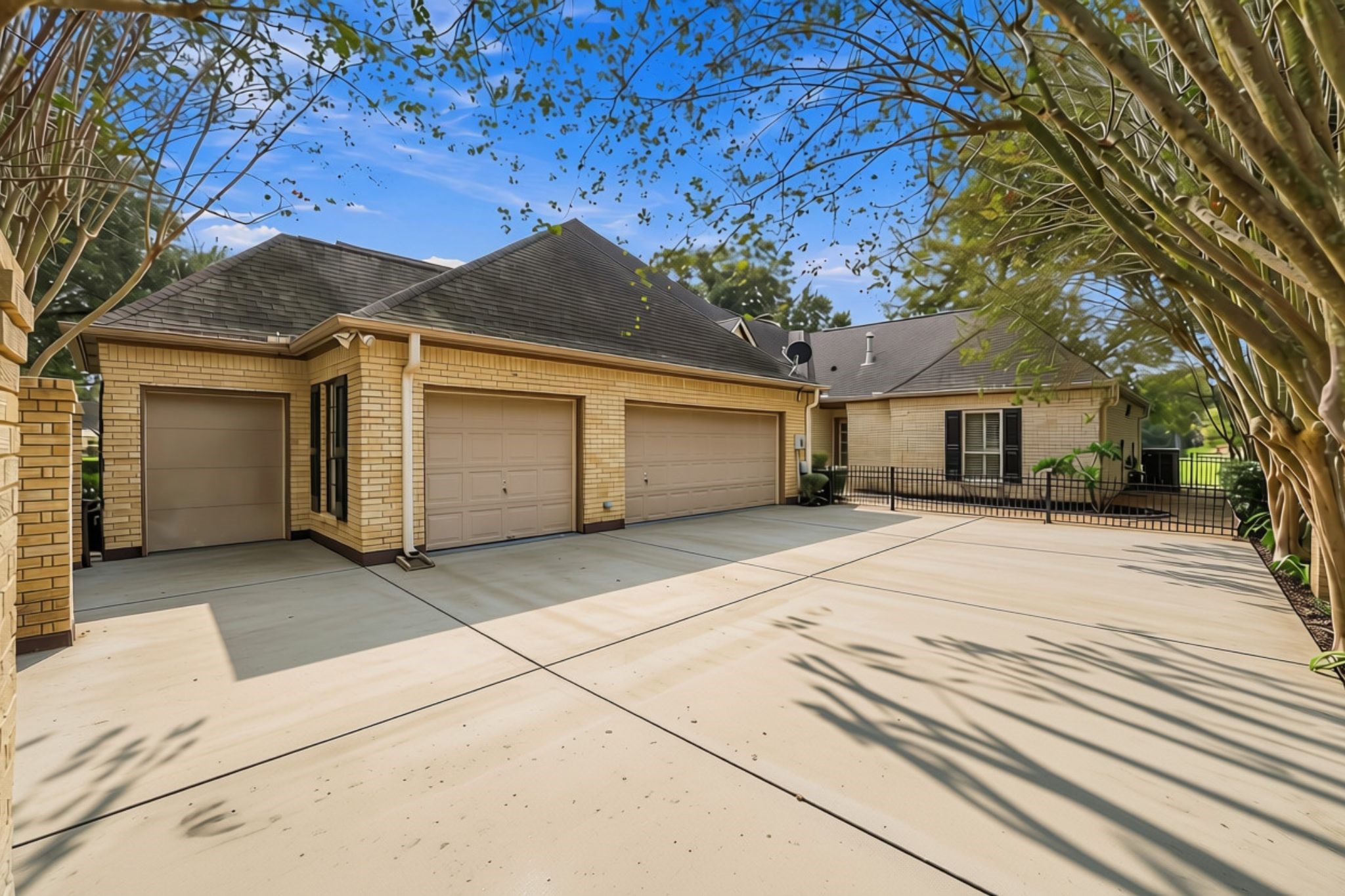 The main residence features a spacious courtyard entry, a 3-Car attached garage, and a separate golf cart garage, along with an abundance of driveway space for additional parking and guest accommodations.