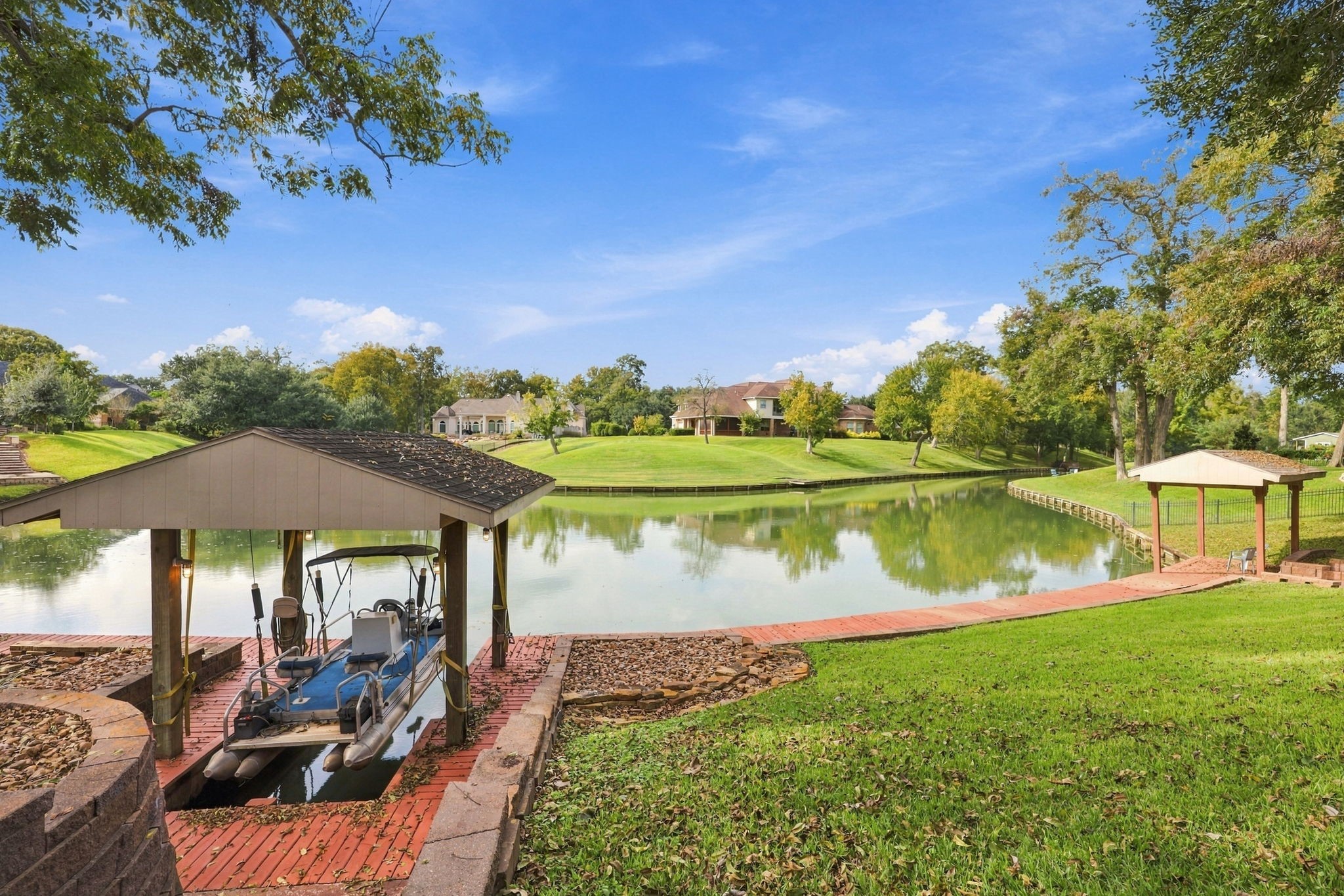 A small pontoon boat with a covered boat lift is included with the property, offering a wonderful opportunity to enjoy leisurely outings on Pecan Lake and take full advantage of the beautiful waterfront setting. Please note: Pecan Lake permits electric motors only. Gasoline-powered or other fuel-operated motors are not allowed.