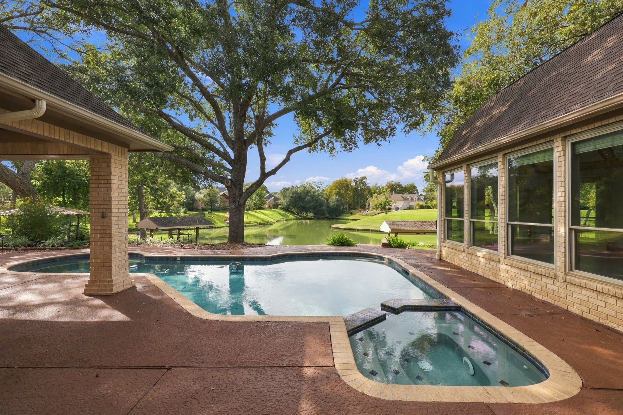 You simply can't get enough of this view! With the sparkling waters of Pecan Lake, beautiful, mature trees, and the inviting pool and spa, every glance reminds you just how special this setting truly is.