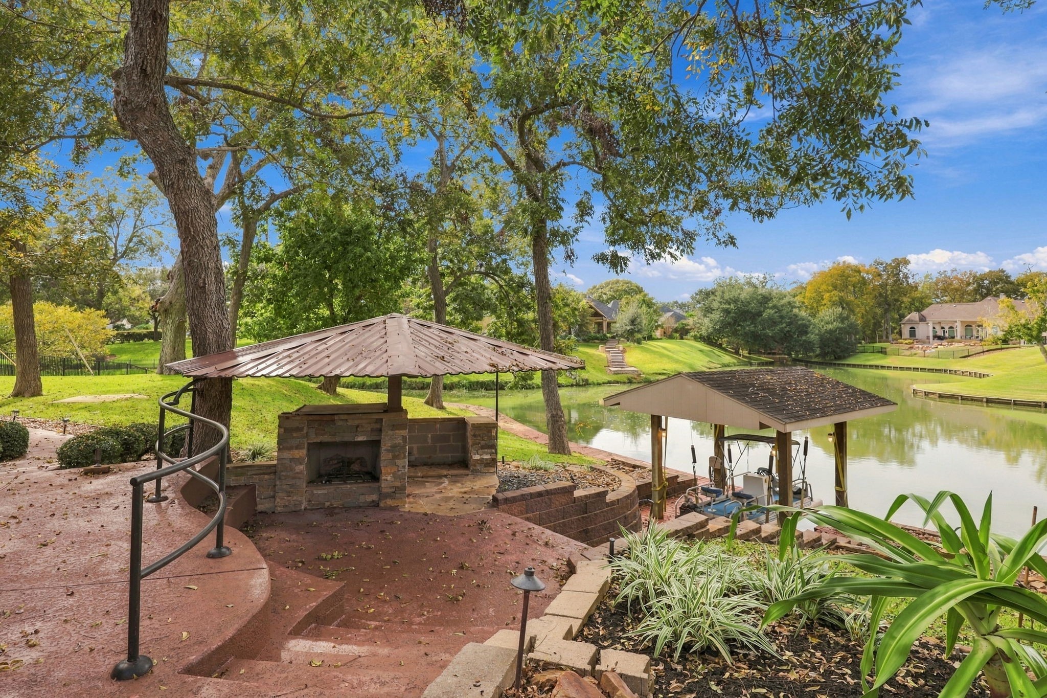 Additional features of this exceptional 1.06-acre estate include a charming outdoor fireplace with a metal roof, along with your very own pontoon boat and boat slip. Surrounded by lush landscaping and picturesque waterfront views, this outdoor setting is perfect for relaxing evenings, entertaining family and friends, and enjoying all the beauty this remarkable property has to offer.