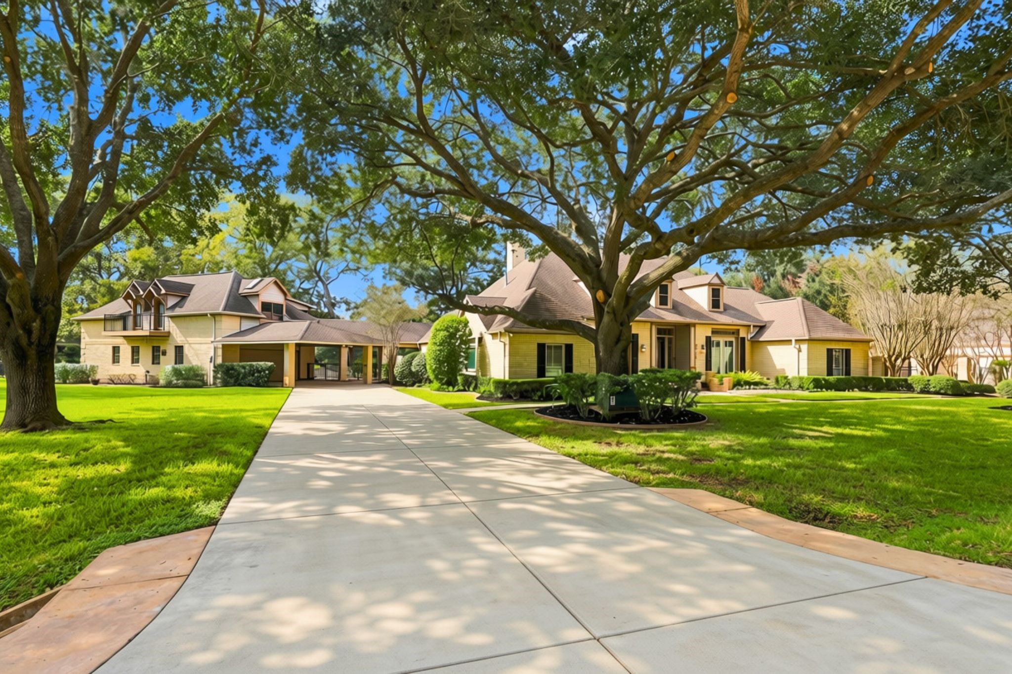 The home features a gorgeous light-brick exterior surrounded by majestic mature oak trees, creating beautiful curb appeal and a picturesque setting. Additional accommodations include a 3-Car Garage attached to the main house, plus a 2-car oversized garage, a 589-sqft. air-conditioned workshop with a half bath, and a separate garage apartment or guest quarters located on the second floor of the addition. These versatile spaces offer exceptional flexibility for guests, extended family and additional storage.