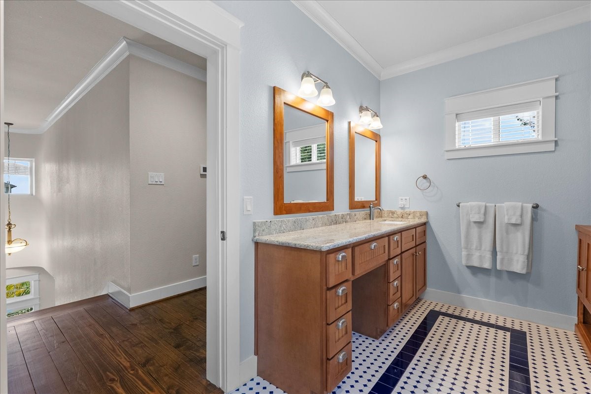 upstairs bath offers dual vanities, generous storage and lots of room.