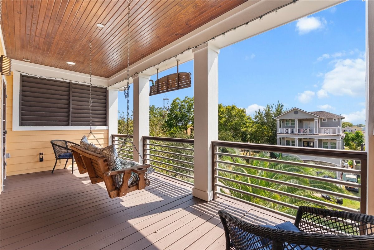 Top-floor covered balcony offers a peaceful retreat to relax and enjoy the coastal breeze.