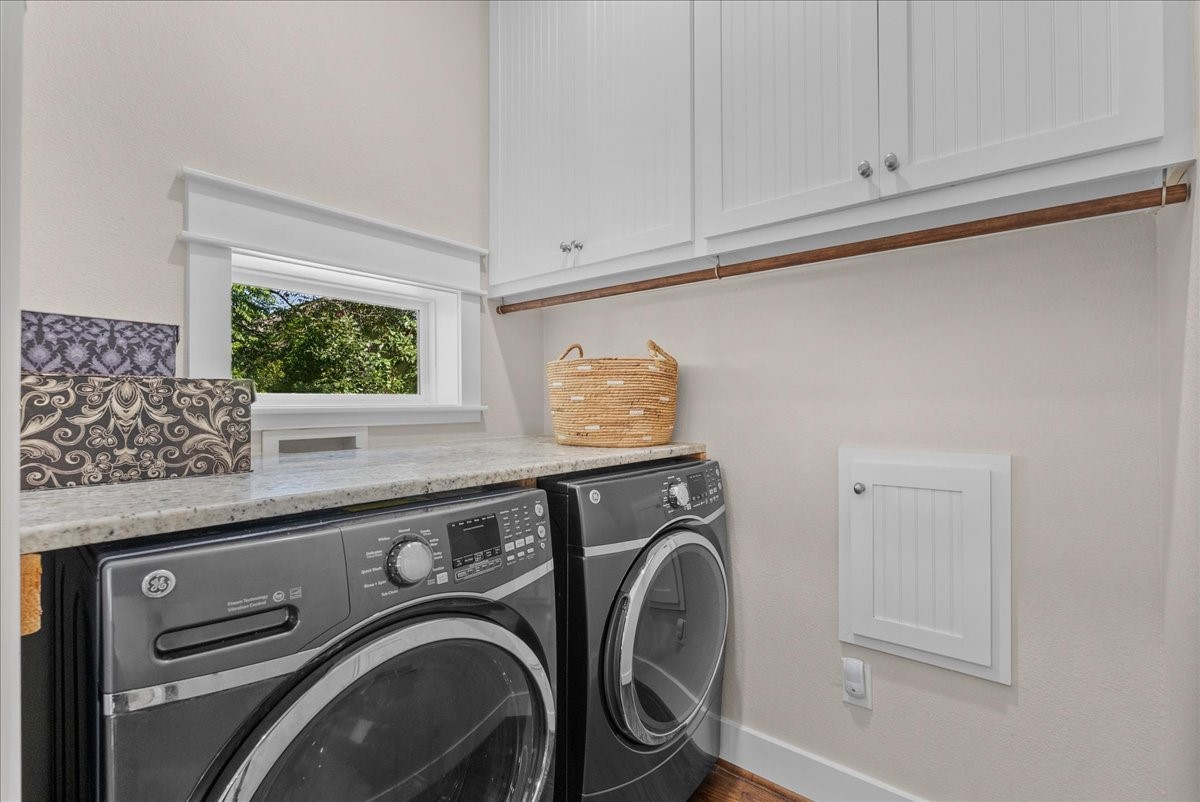Well, designed laundry room with folding area and storage