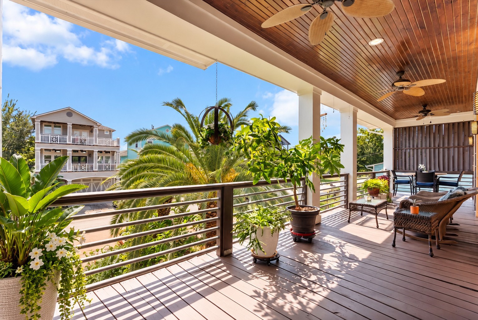 Expansive covered balcony offers a relaxing outdoor living space overlooking the tropical surroundings of Clear Lake Shores.