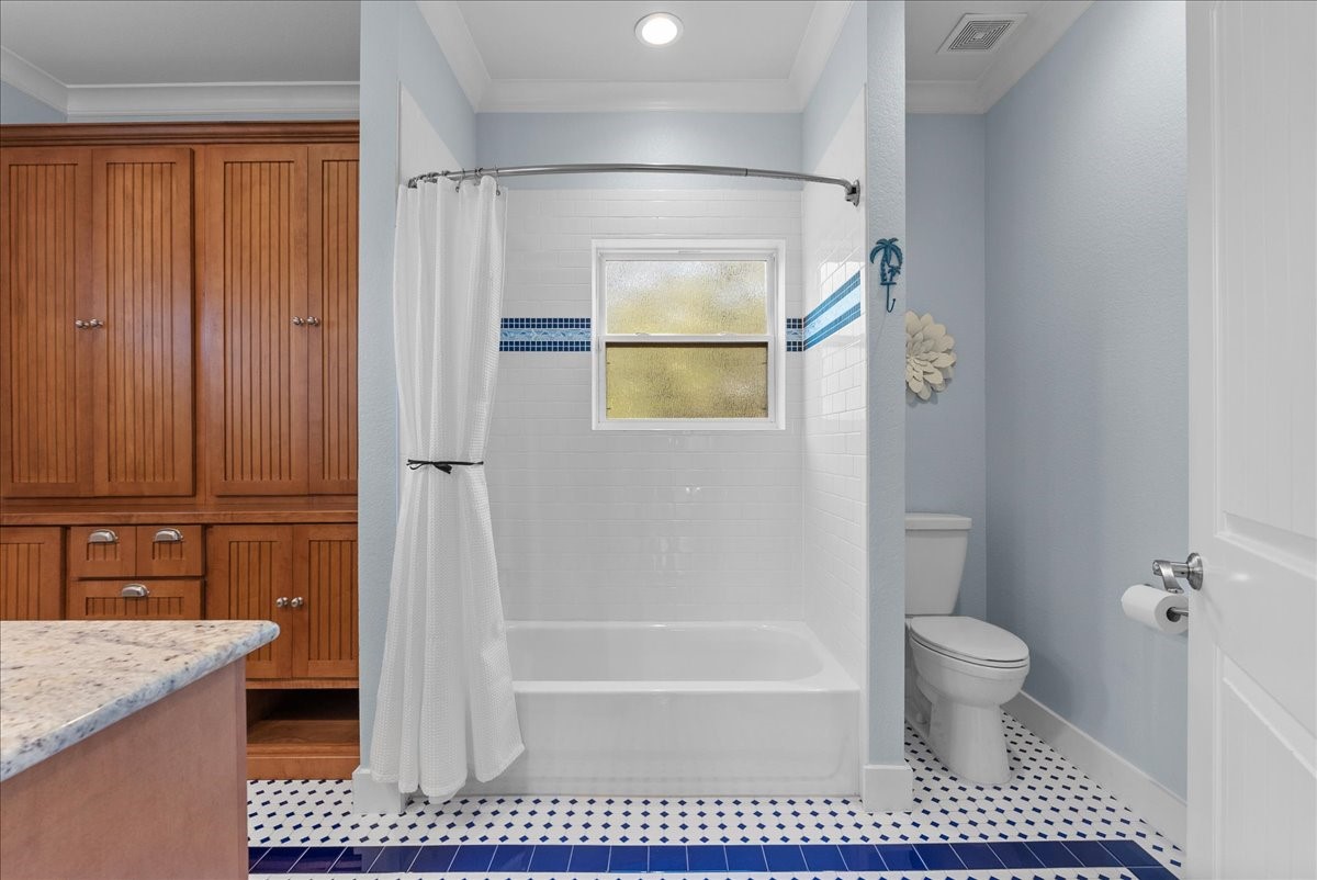 Roomy second-floor bath shared by the two secondary bedrooms, featuring abundant cabinetry, dual vanities and a tub/shower combination plus large storage closet.