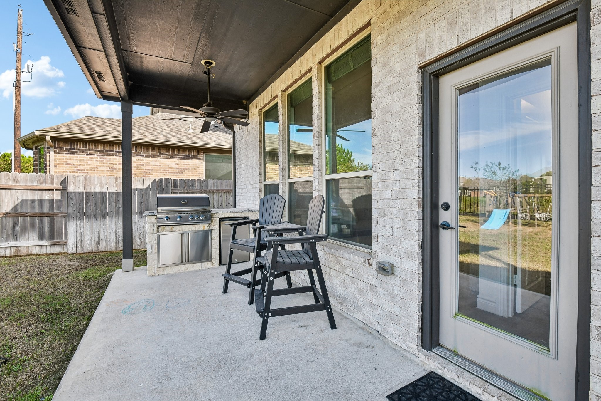 Covered patio with built-in grill and room for outdoor dining or lounge seating