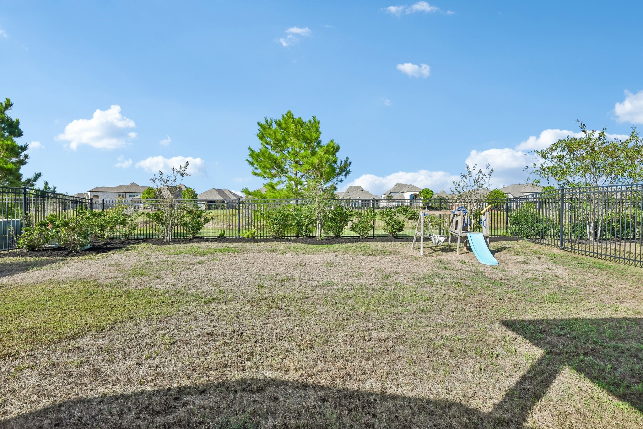 Second backyard view showing the depth of the lot and usable green space