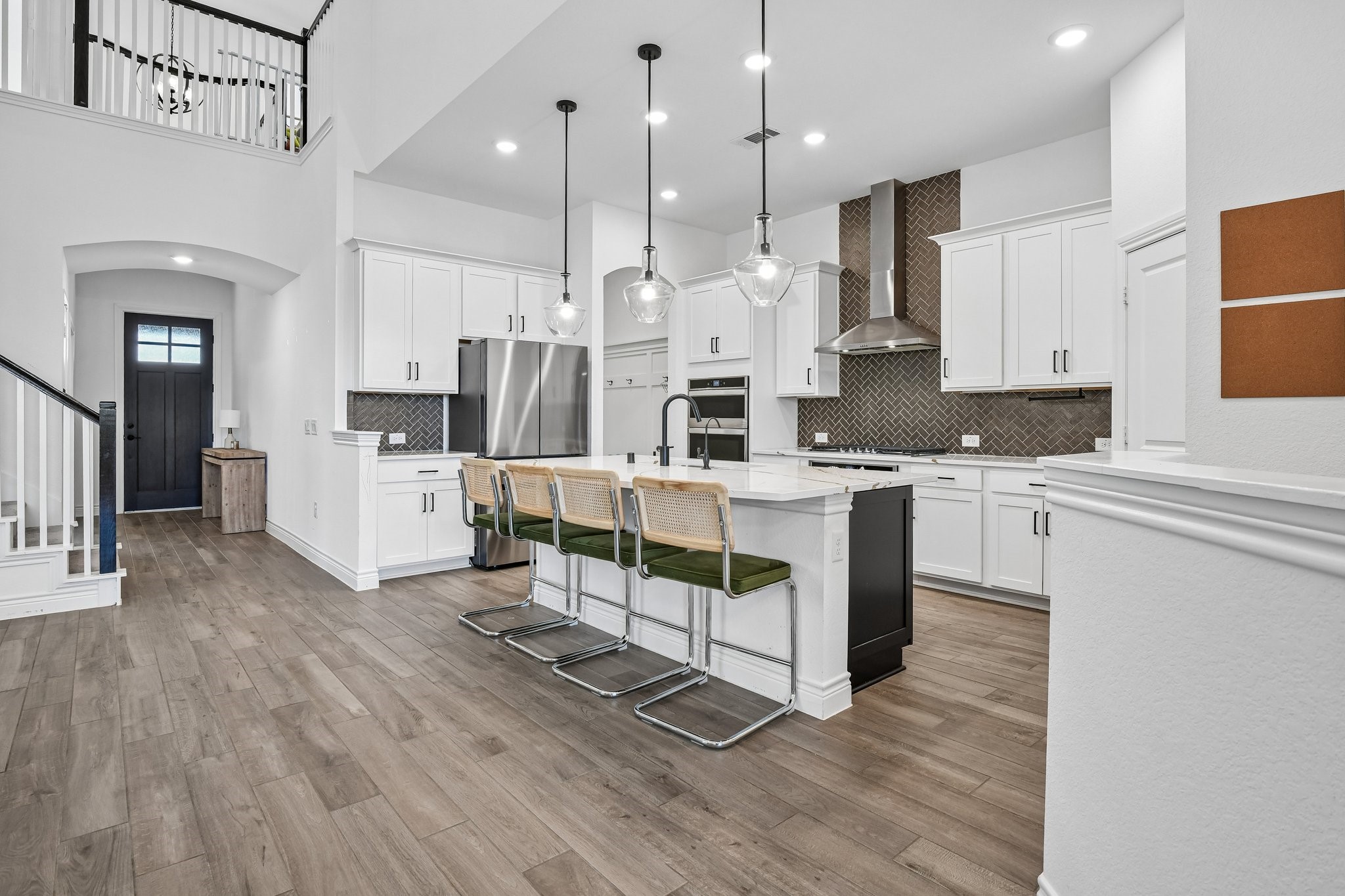 Second kitchen angle showing white cabinetry, extended counters, and clear flow into the dining area