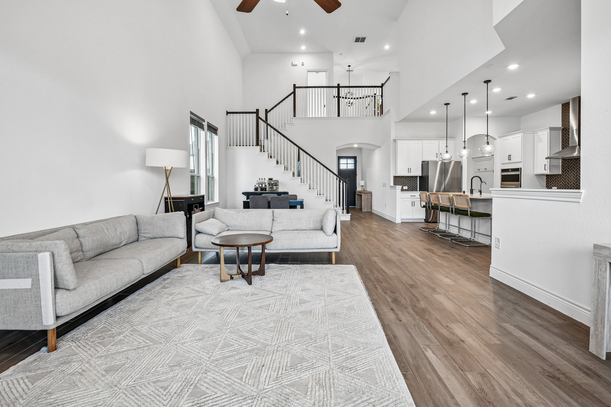 Two-story family room opens to the kitchen and dining space for an uninterrupted main-level layout