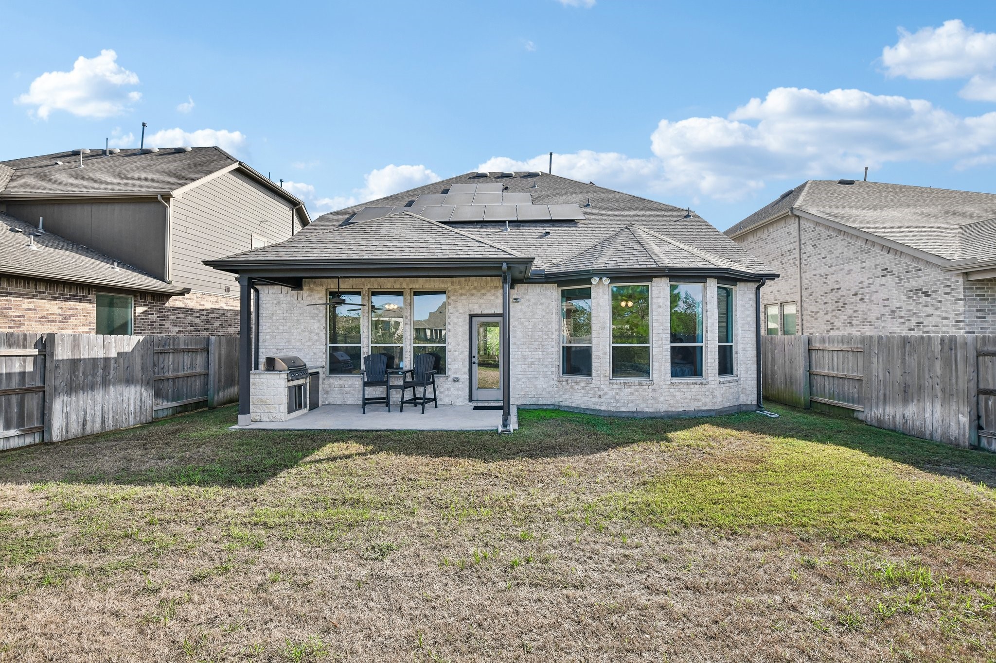 Full rear exterior showing the home centered across the width of the lot