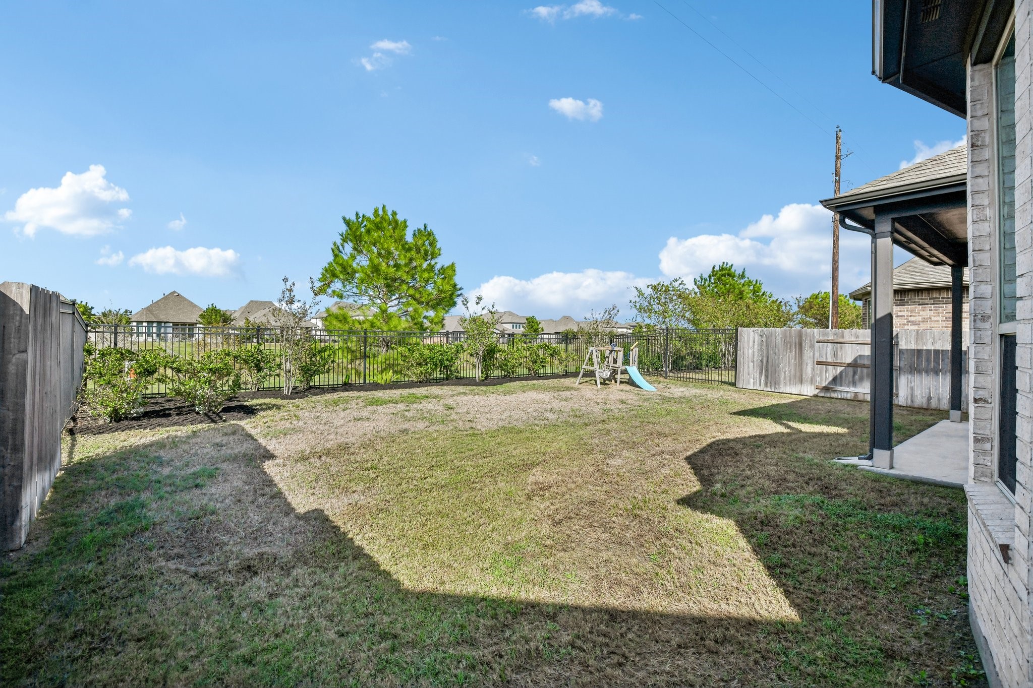 Large fenced backyard with open lawn and room for future outdoor improvements