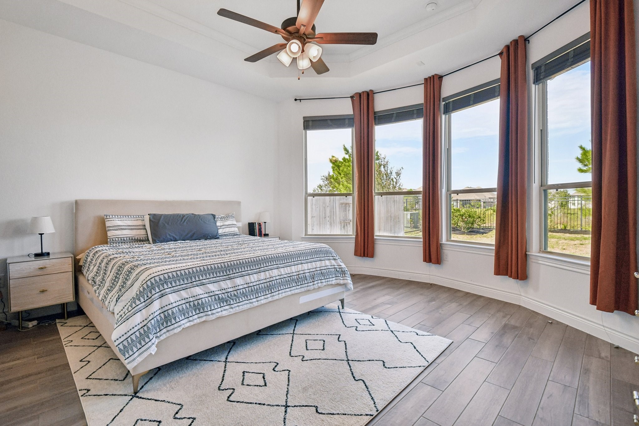 Second primary suite angle highlighting the wall of windows and natural light