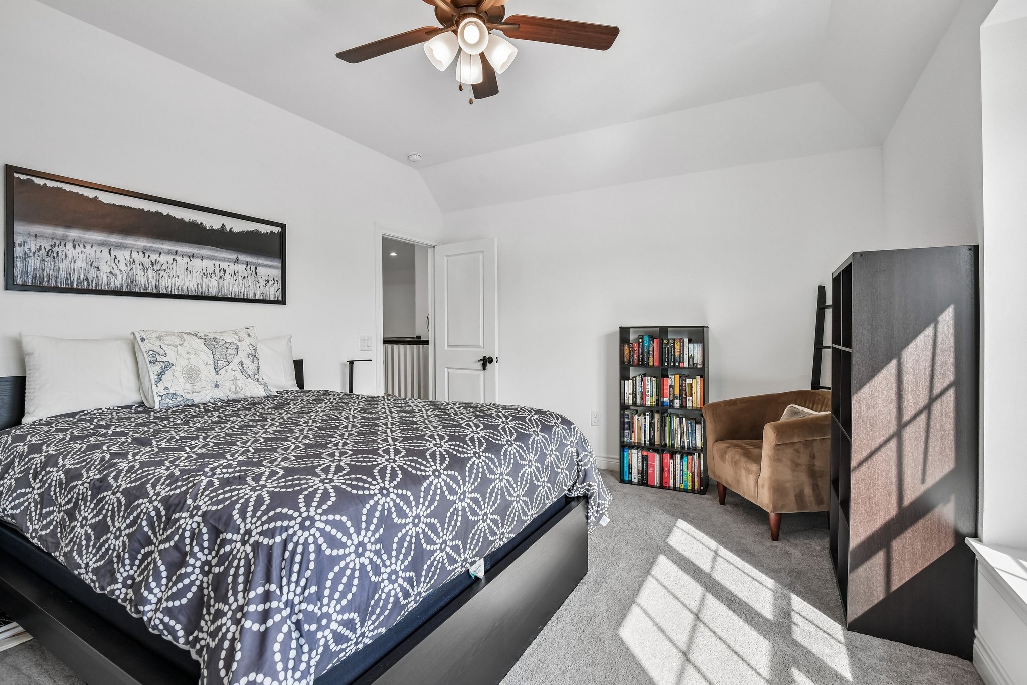 Additional upstairs bedroom with neutral finishes, ceiling fan, and closet