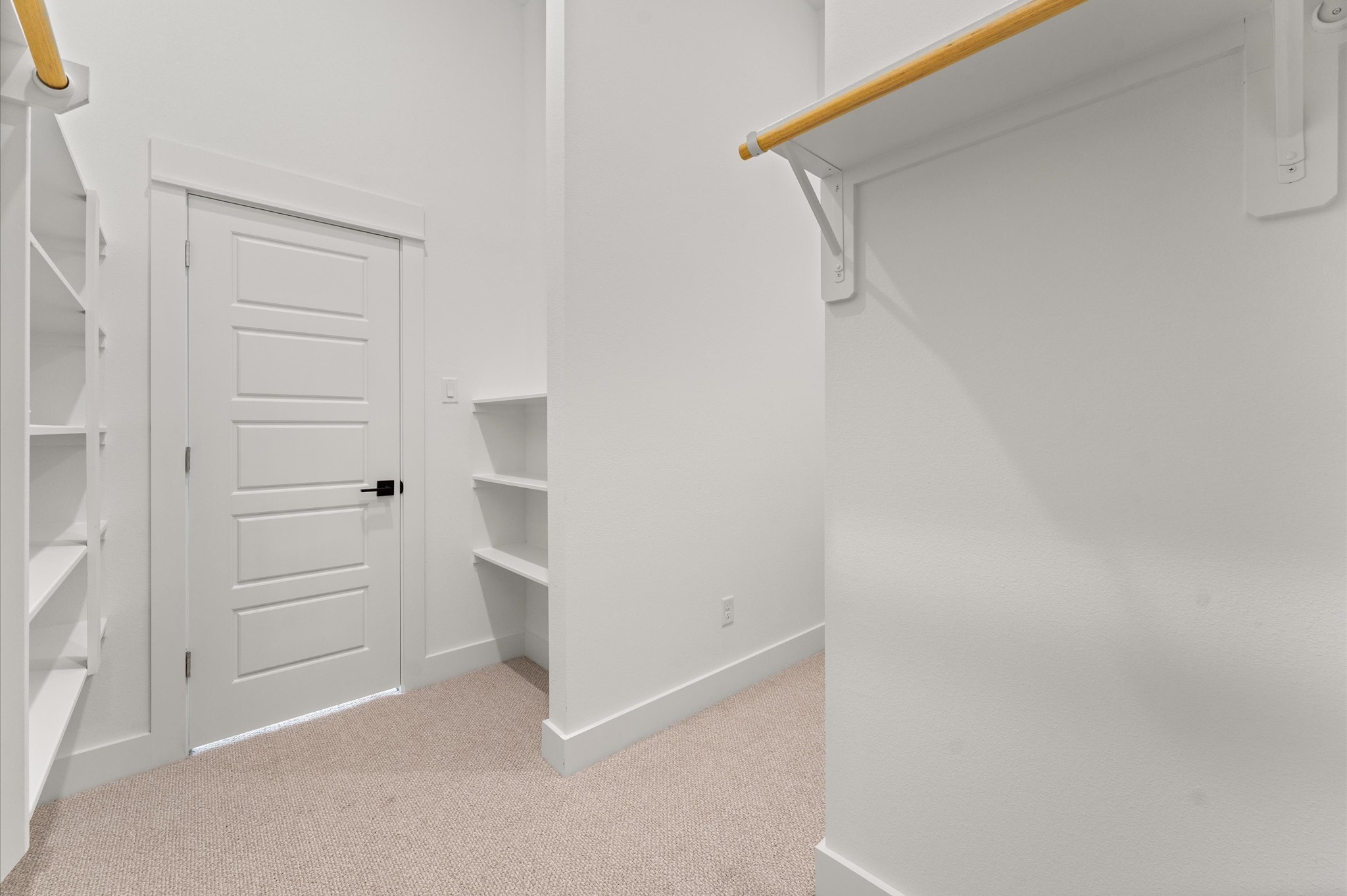 This expansive walk-in closet is a standout feature of the primary bedroom, offering generous space for wardrobe organization and personal storage. Thoughtfully designed shelving and hanging rods, the closet provides a boutique-like experience with room for everything from seasonal clothing to accessories.