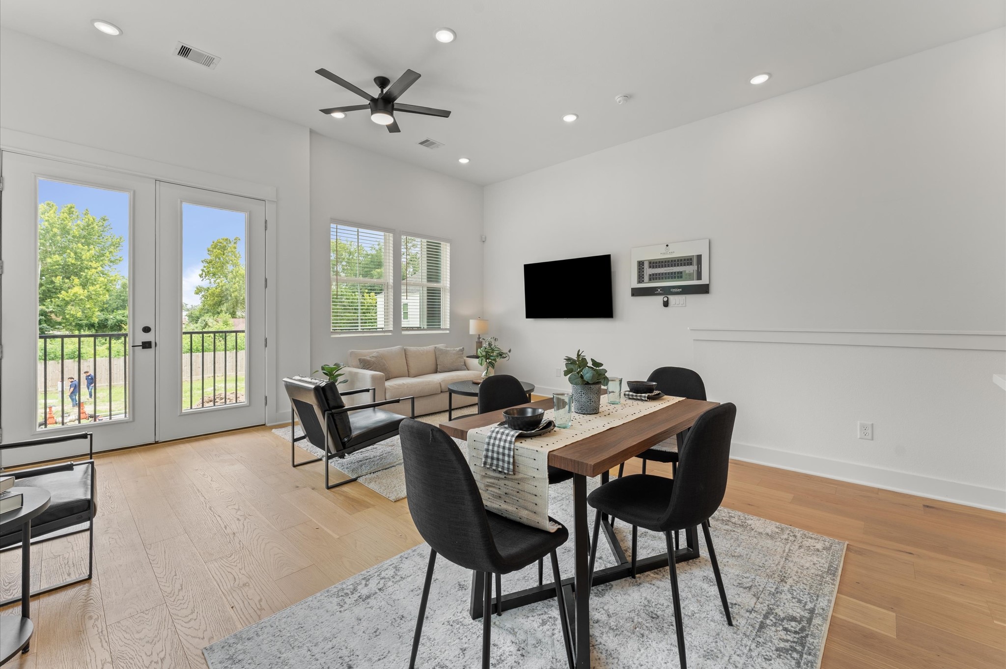 Adjacent dining area easily accommodates a full-size table, while the living space is inviting with cozy seating and access to a private balcony