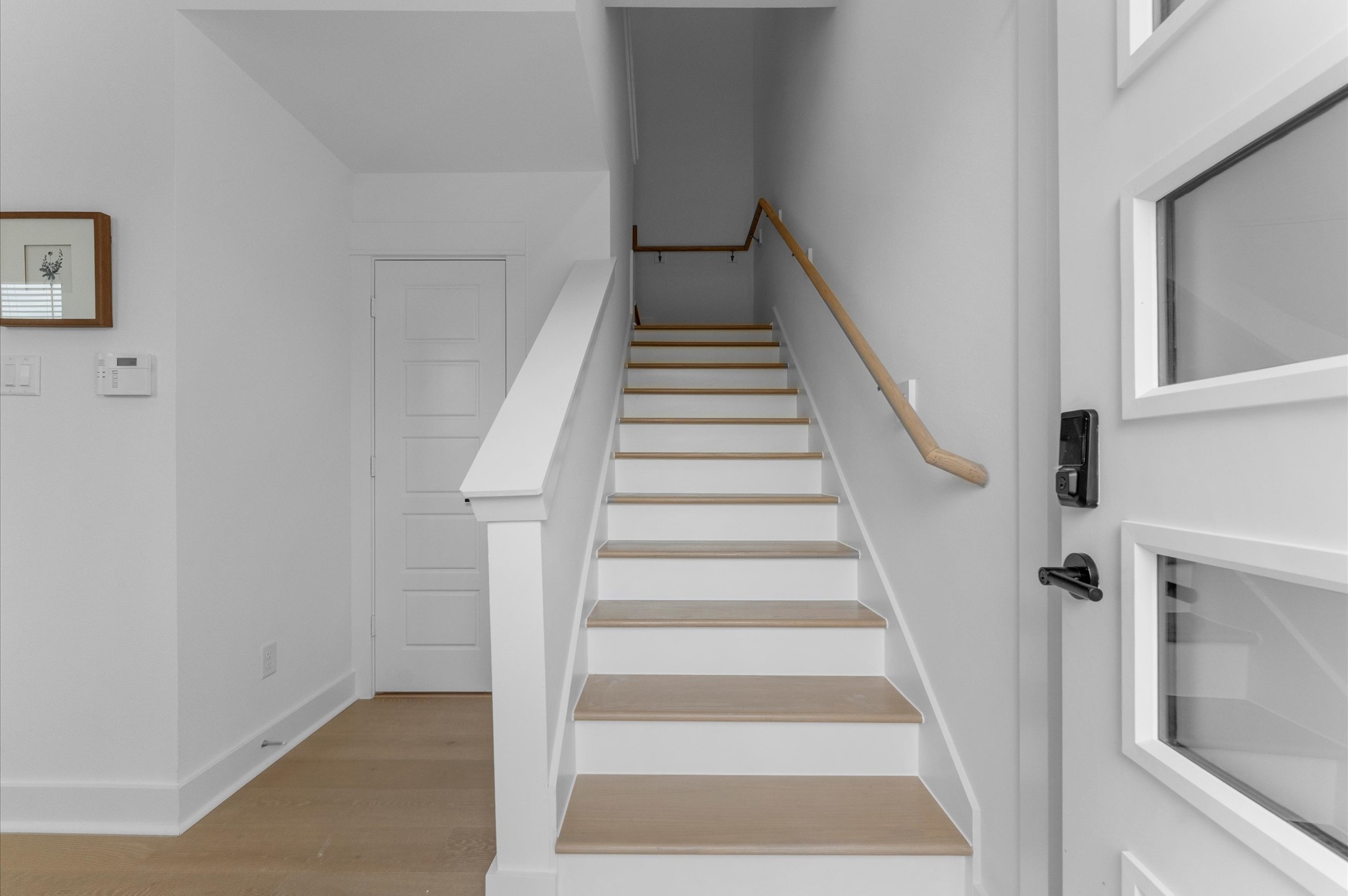 Elegant staircase serves as a stylish transition from the first to the second floor, combining architectural charm with functional design. The steps feature sleek wood or contemporary tile finishes, complemented by minimalist railings.