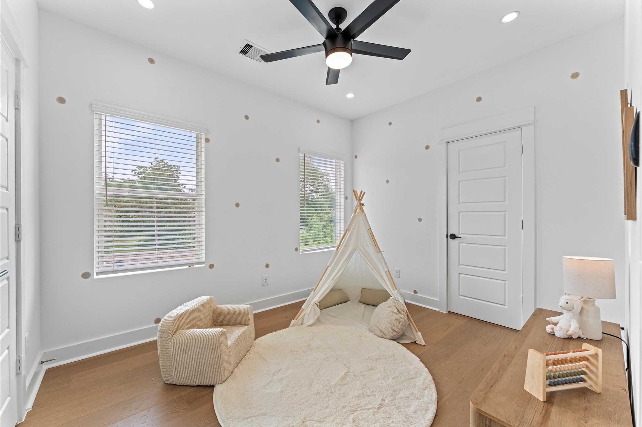 Versatile secondary bedroom on the first floor, thoughtfully staged as a home office yet adaptable to suit any lifestyle need. The space boasts warm natural light, neutral tones, and easy access to a shared Jack and Jill bathroom, adding both function and privacy.