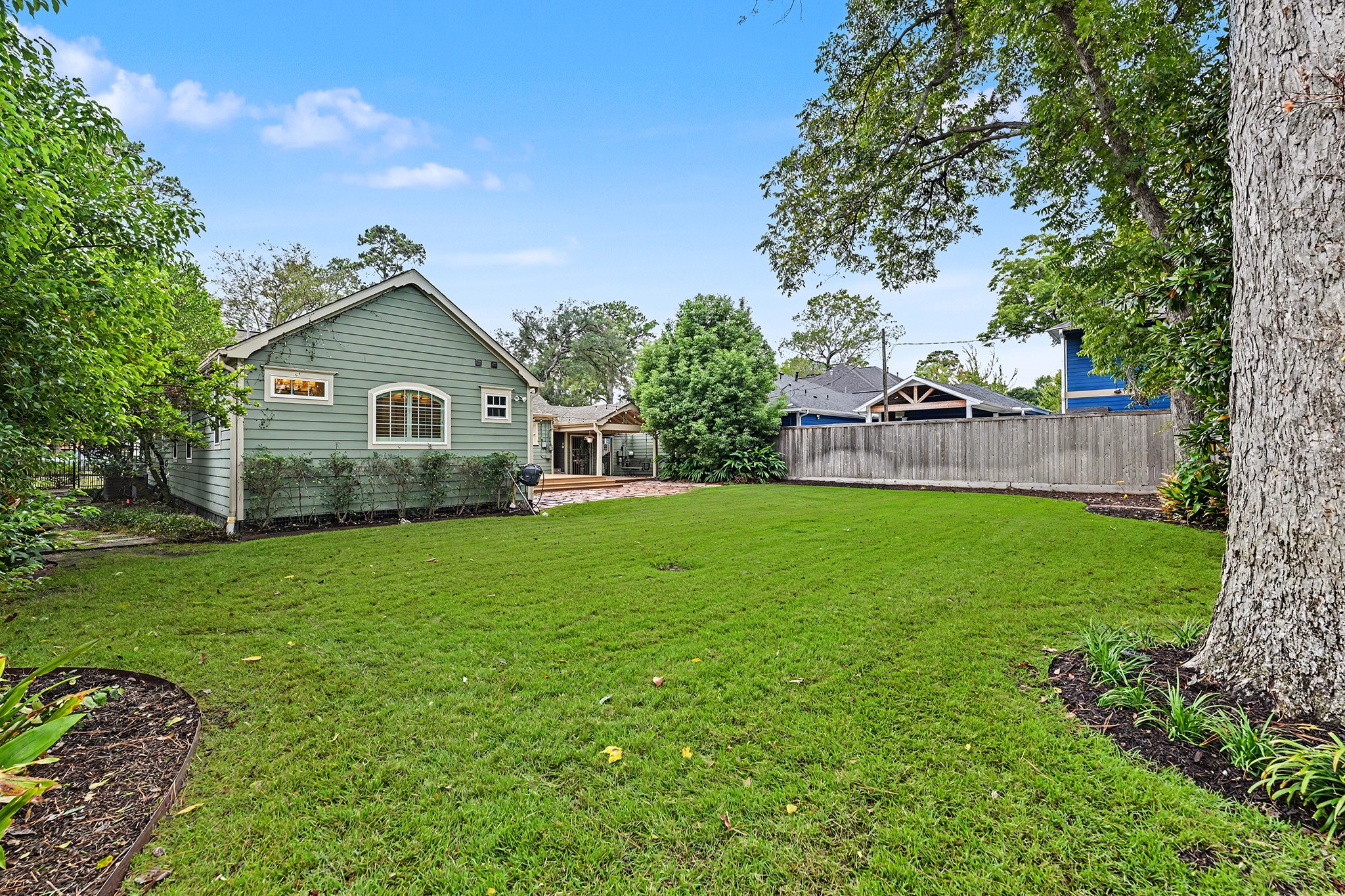 The expansive, fully fenced backyard offers plenty of room for pets, play, gardening or even a pool.
