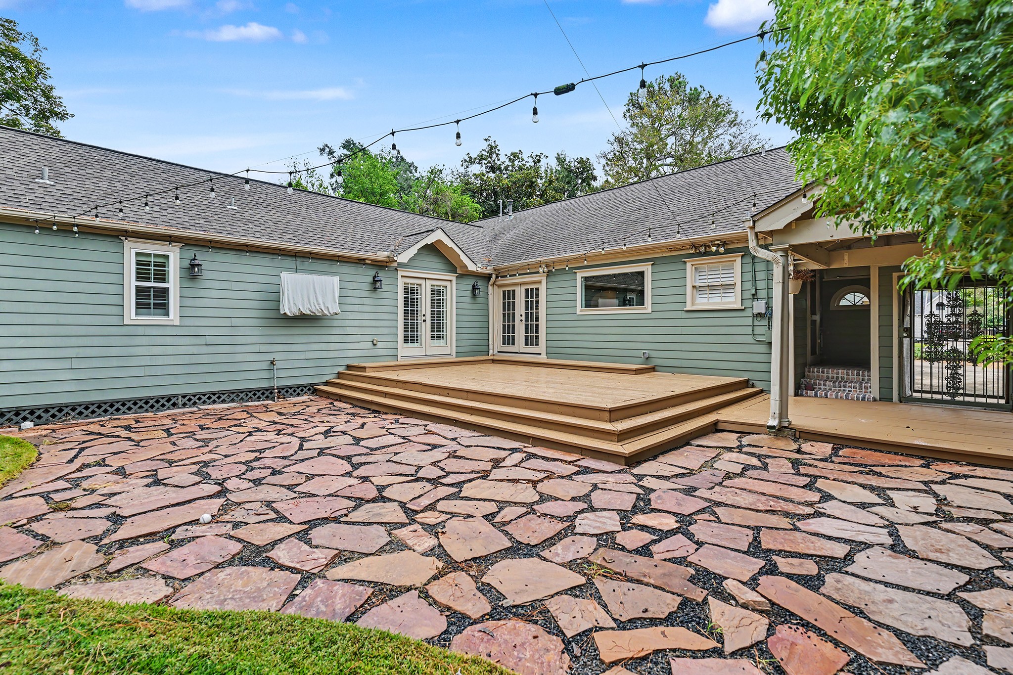 The spacious backyard is ideal for entertaining or relaxing, with a paver patio, large deck, covered side deck and convenient access to the home.